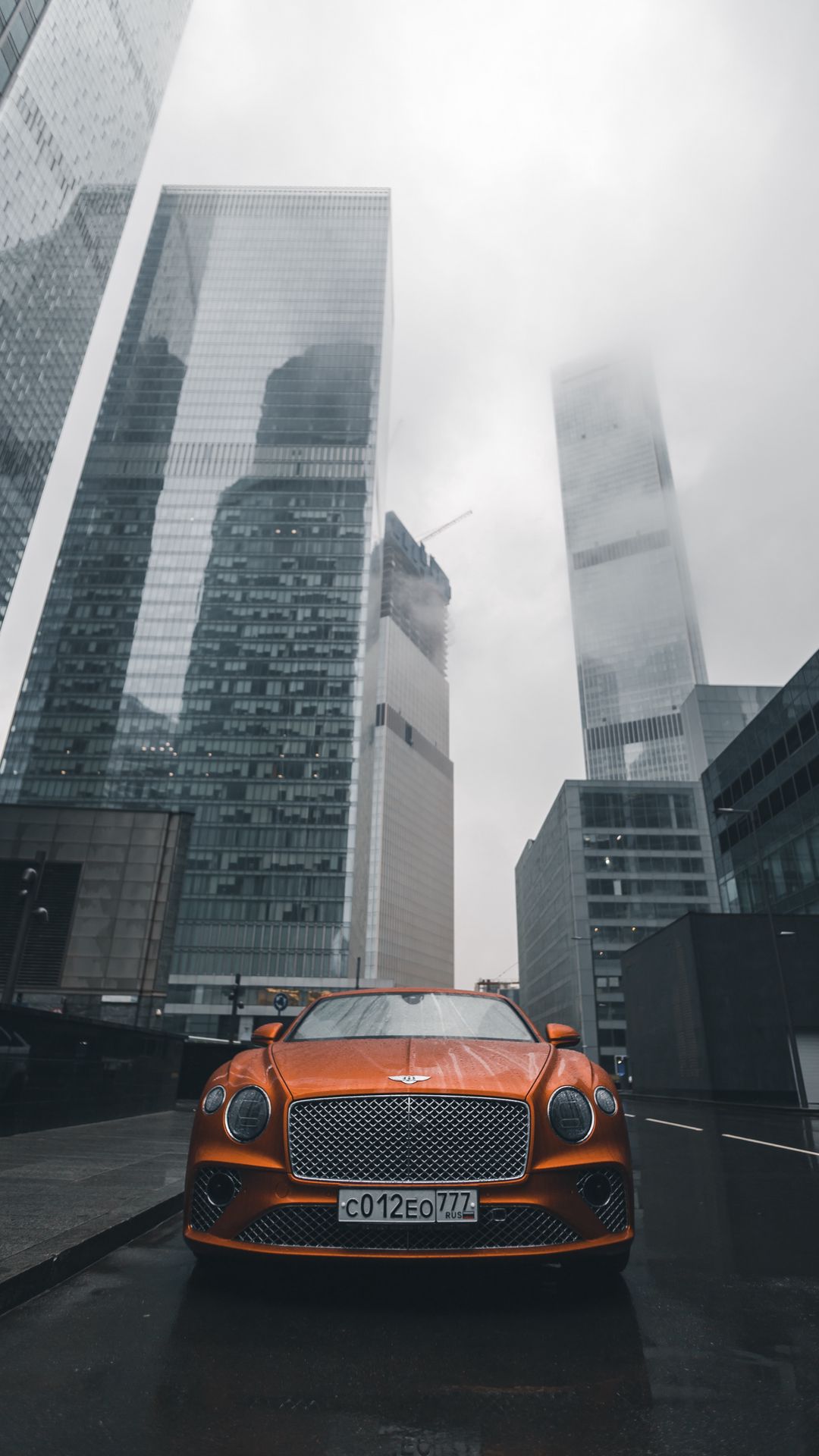Download wallpaper 1080x1920 bentley continental gt, bentley, car, orange, front view, city, buildings samsung galaxy s s note, sony xperia z, z z z htc one, lenovo vibe HD background