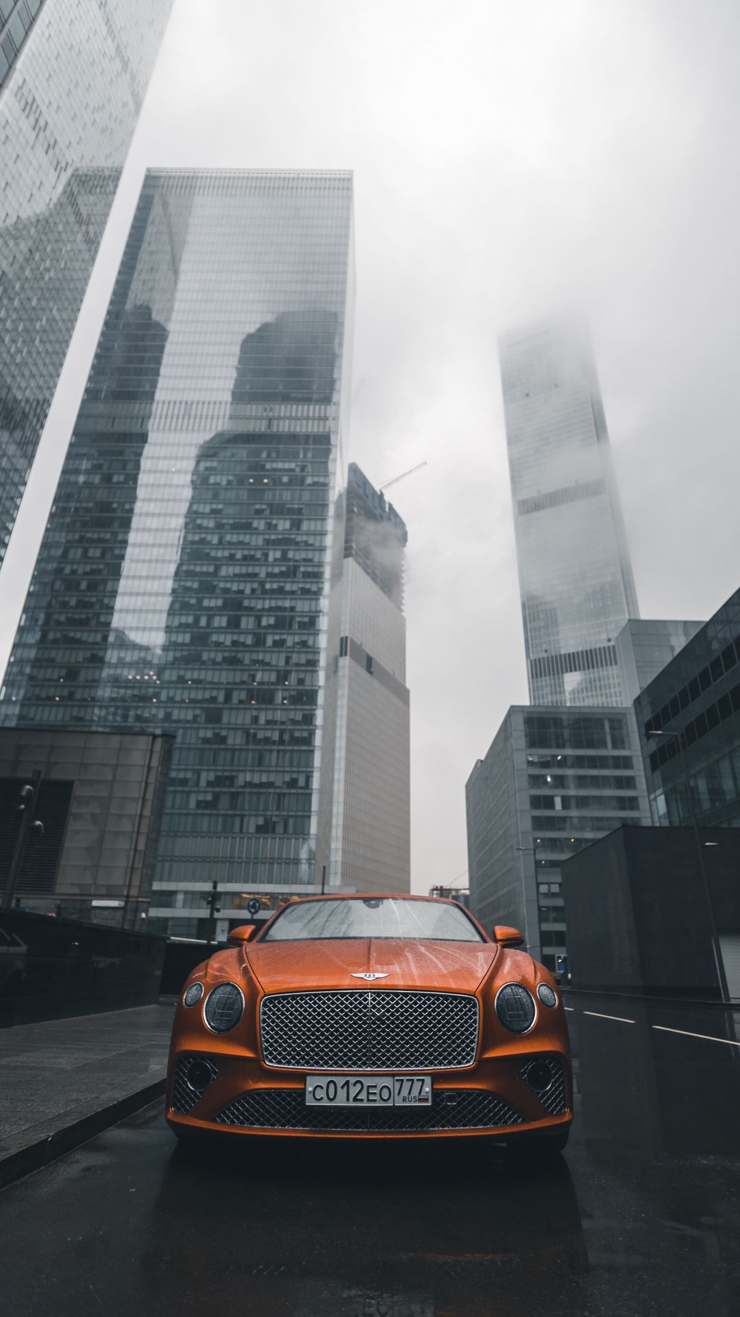 Download wallpaper 1080x1920 bentley continental gt, bentley, car, orange, front view, city, buildings samsung galaxy s4, s5, note, sony xperia z, z1, z2, z3, htc one, lenovo vibe HD background