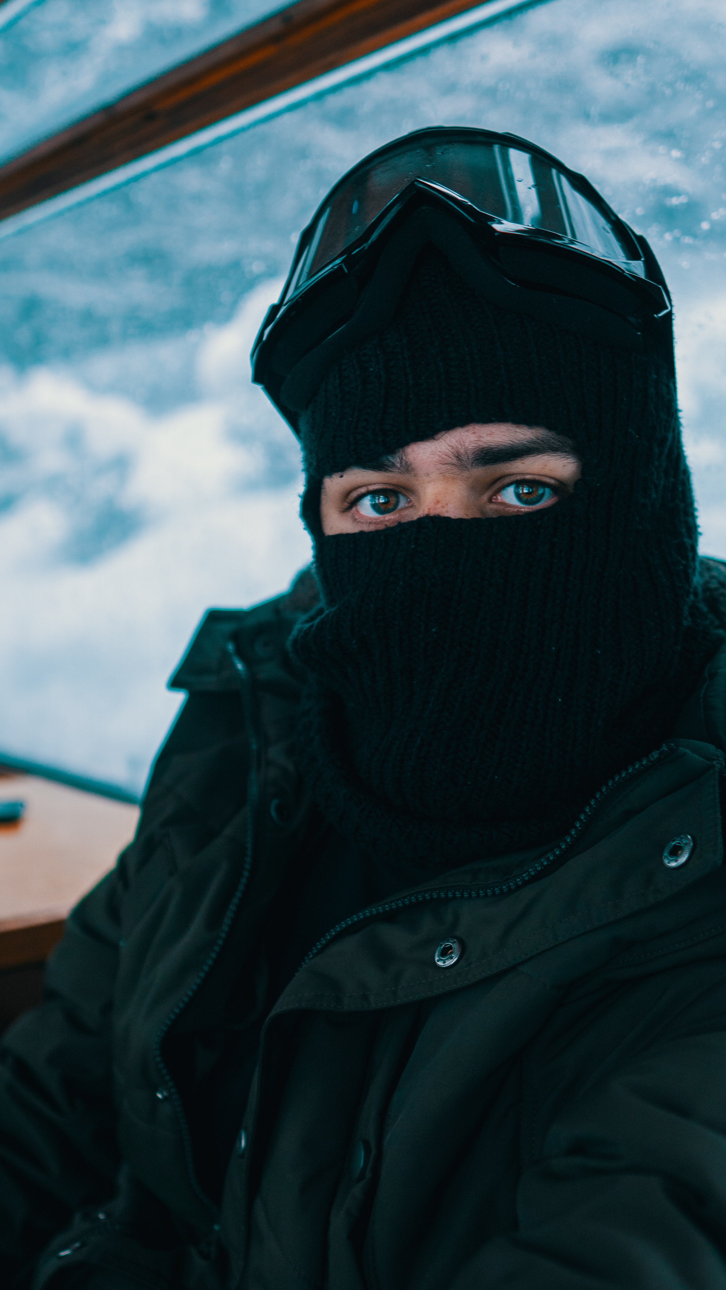 A Tattooed Person Wearing a Ski Mask and a Hoodie · Free