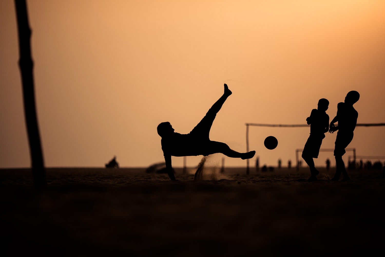 Action Packed Photo Of People Playing Football Soccer At Sunset