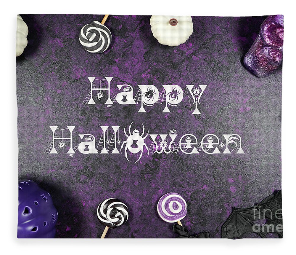 Halloween trick or treat flatlay on purple background with white Fleece Blanket