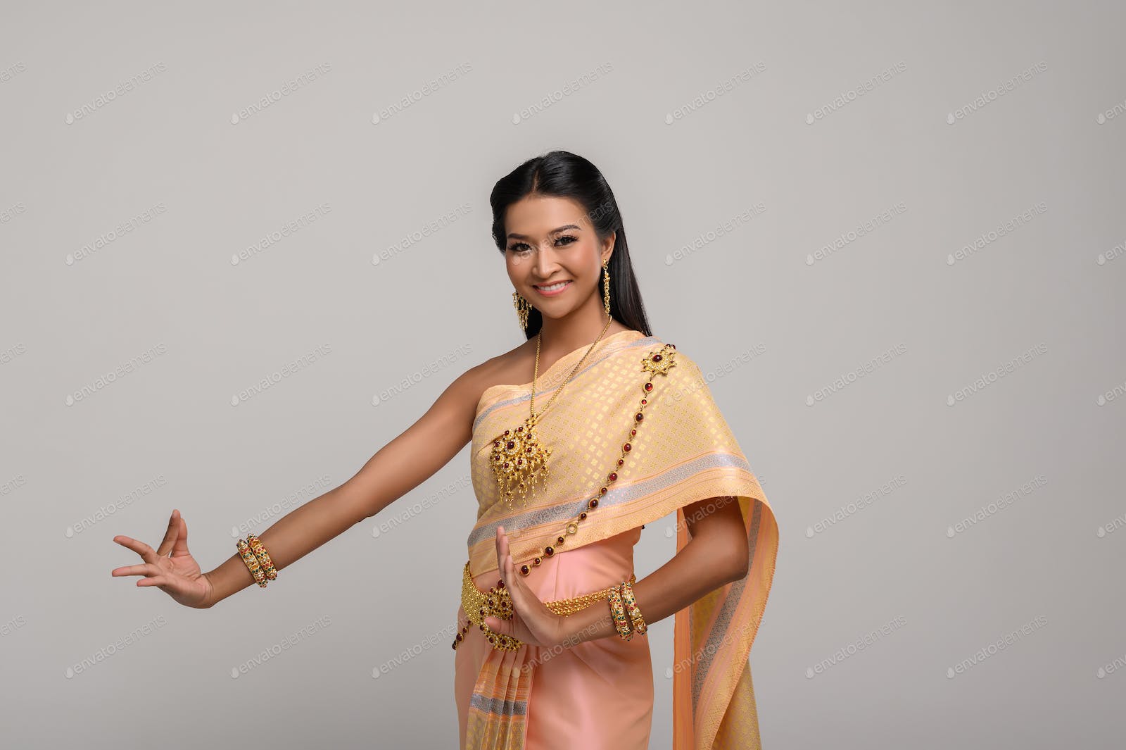 Beautiful Thai woman wearing Thai dress and Thai dance photo by Johnstocker on Envato Elements