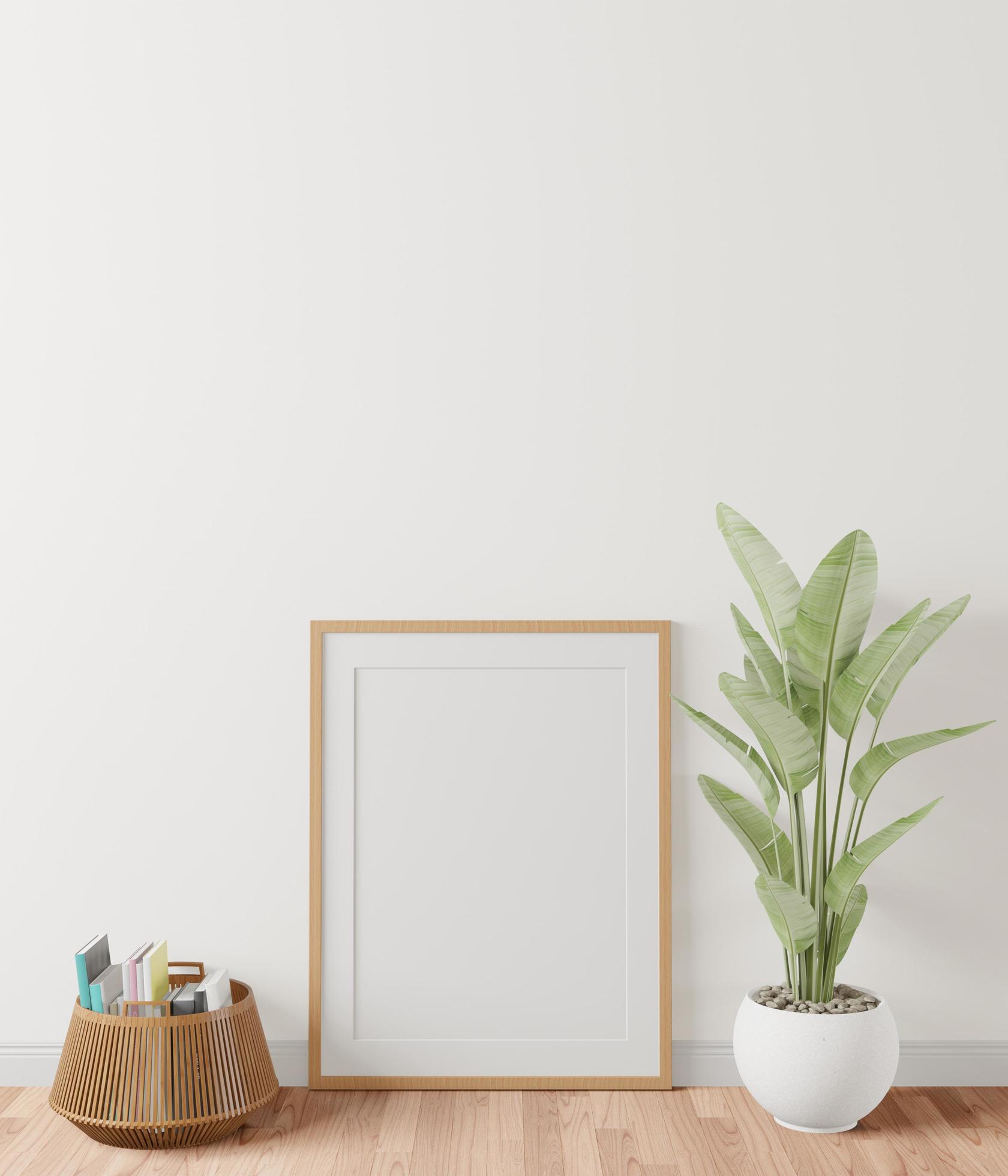 The living room is decorated with furniture, small plant pots and picture frames