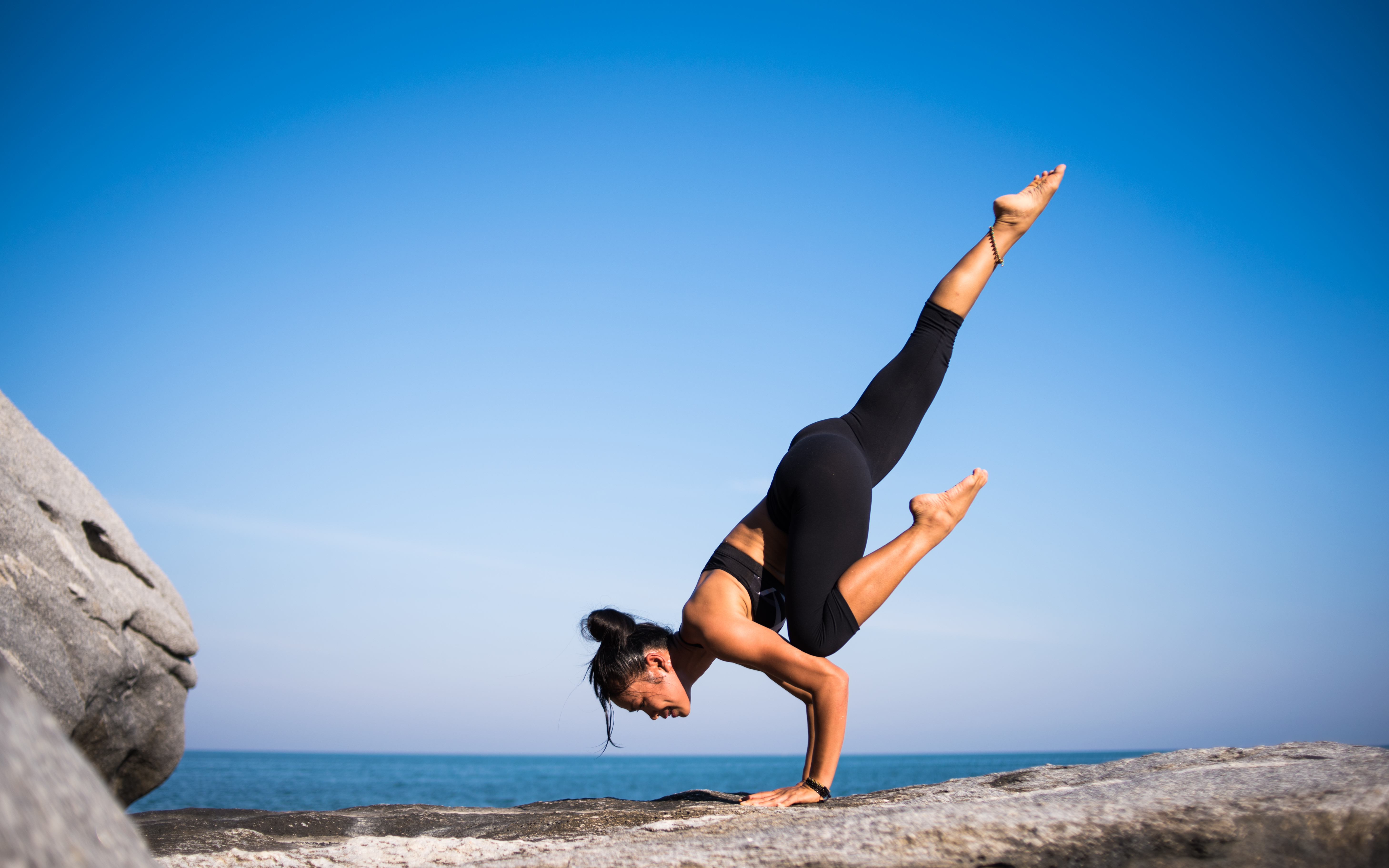 Low Angle View of Woman Relaxing on Beach Against Blue Sky · Free