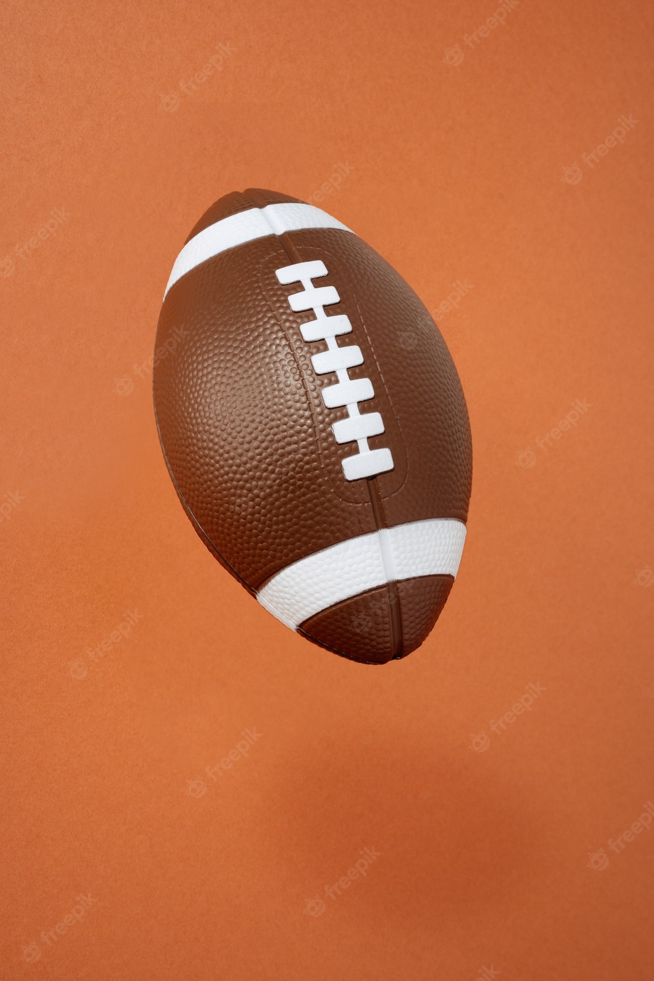 Premium Photo. American football on orange background. sport and competition. copy space. 3D illustration