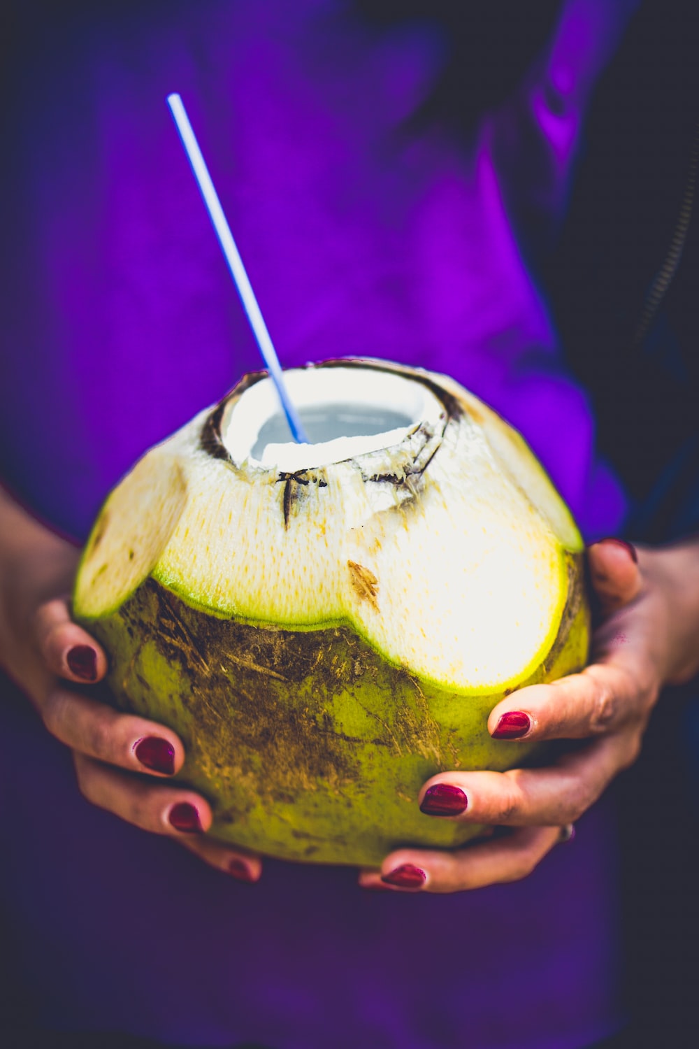person holding coconut juice photo