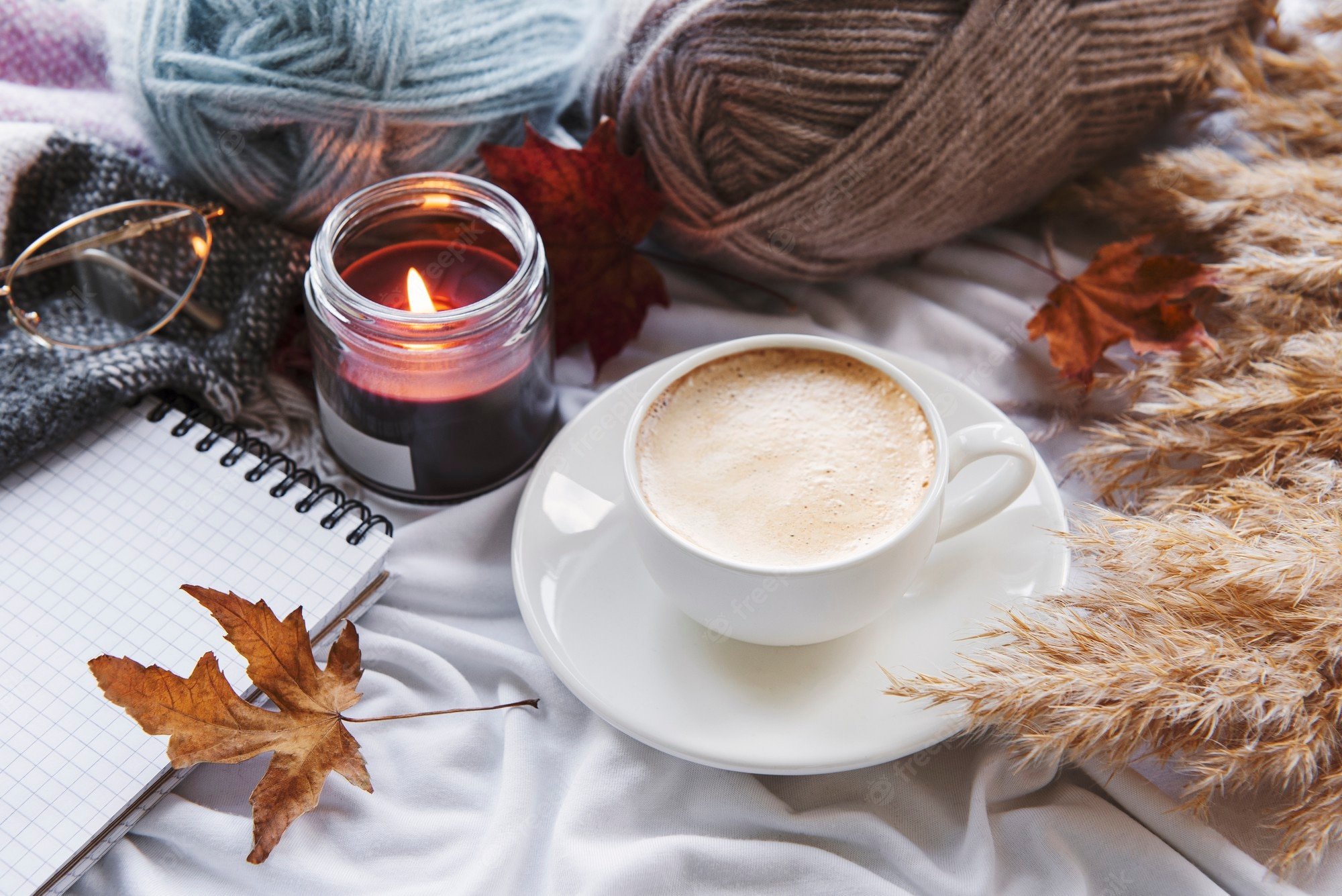 Premium Photo. Autumn still life with pumpkins, coffee and burning candles. cozy fall composition