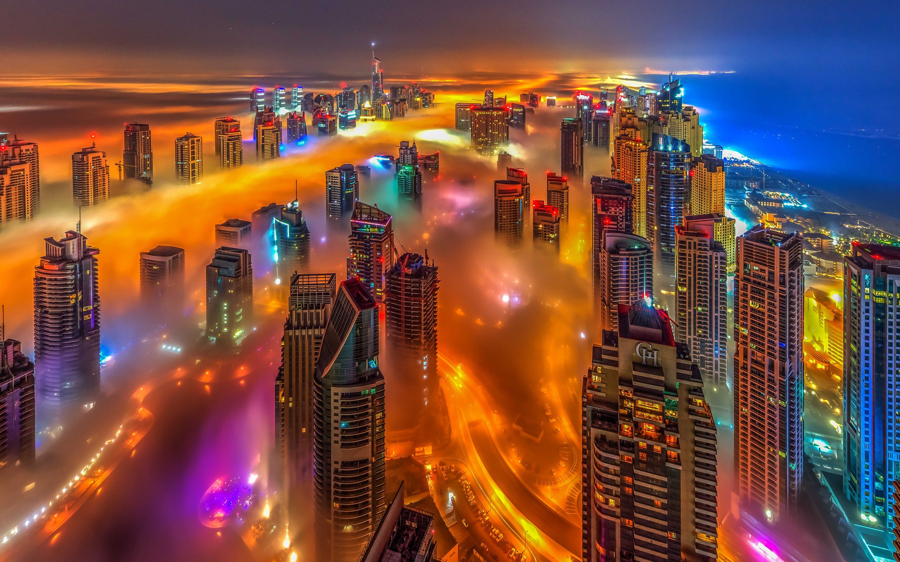 Download wallpaper Dubai, UAE, bright colored city lights, metropolis, skyscrapers above the clouds, night, modern architecture for desktop with resolution 2880x1800. High Quality HD picture wallpaper