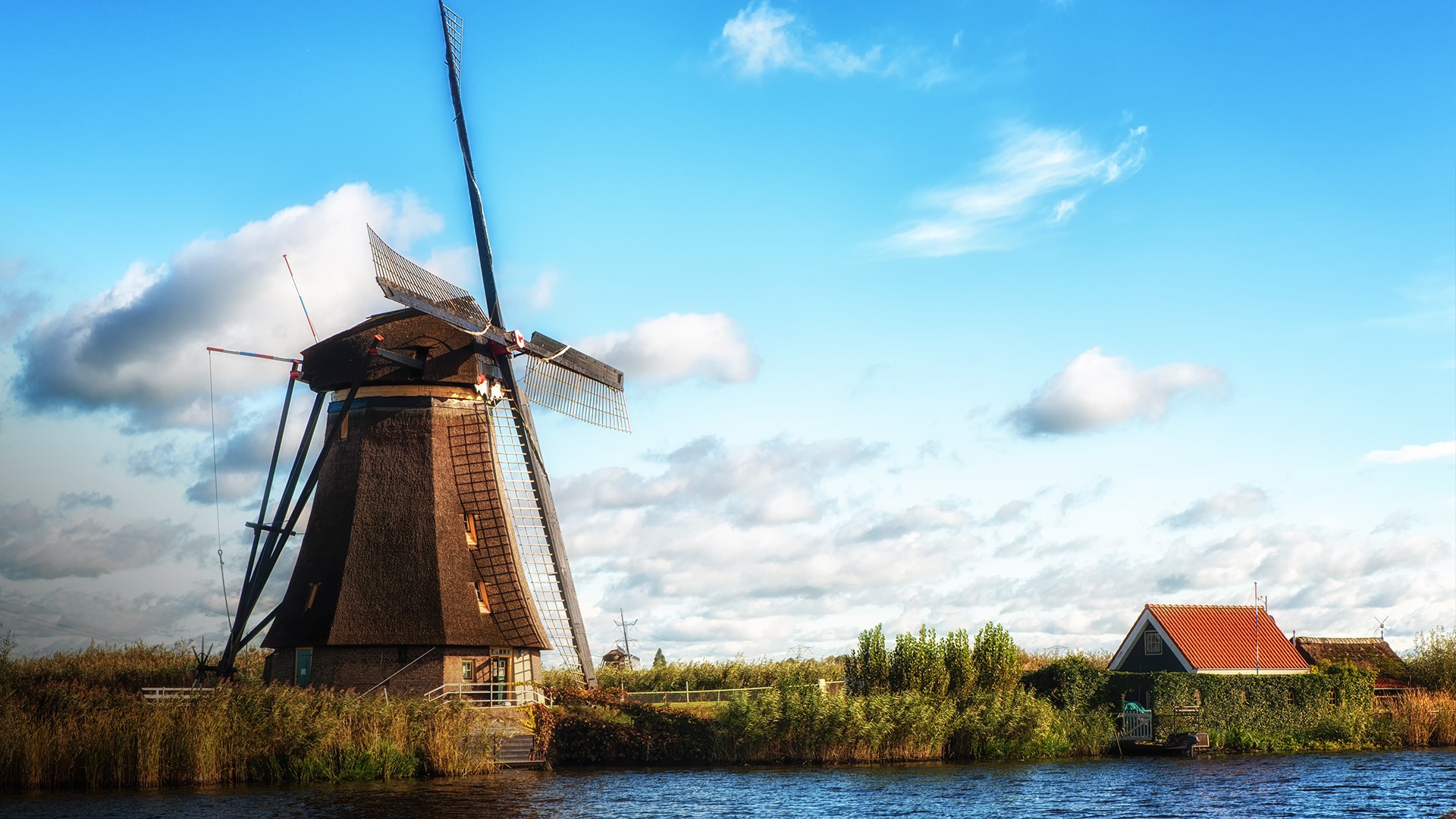 Traditional dutch windmill near the river, Kinderdijk, Netherlands. Windows 10 Spotlight Image