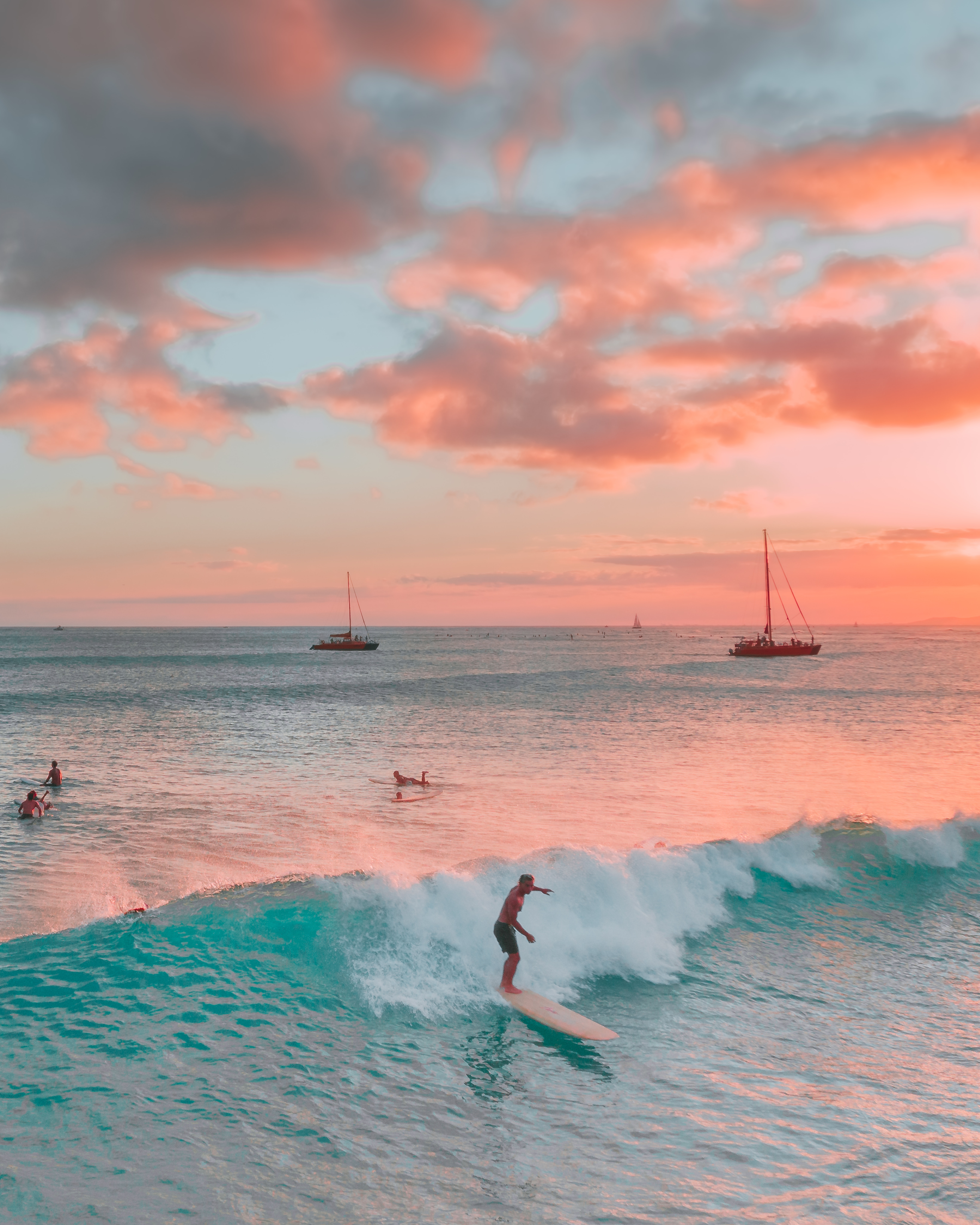 People on their Surfboards at the Beach during Sunset · Free