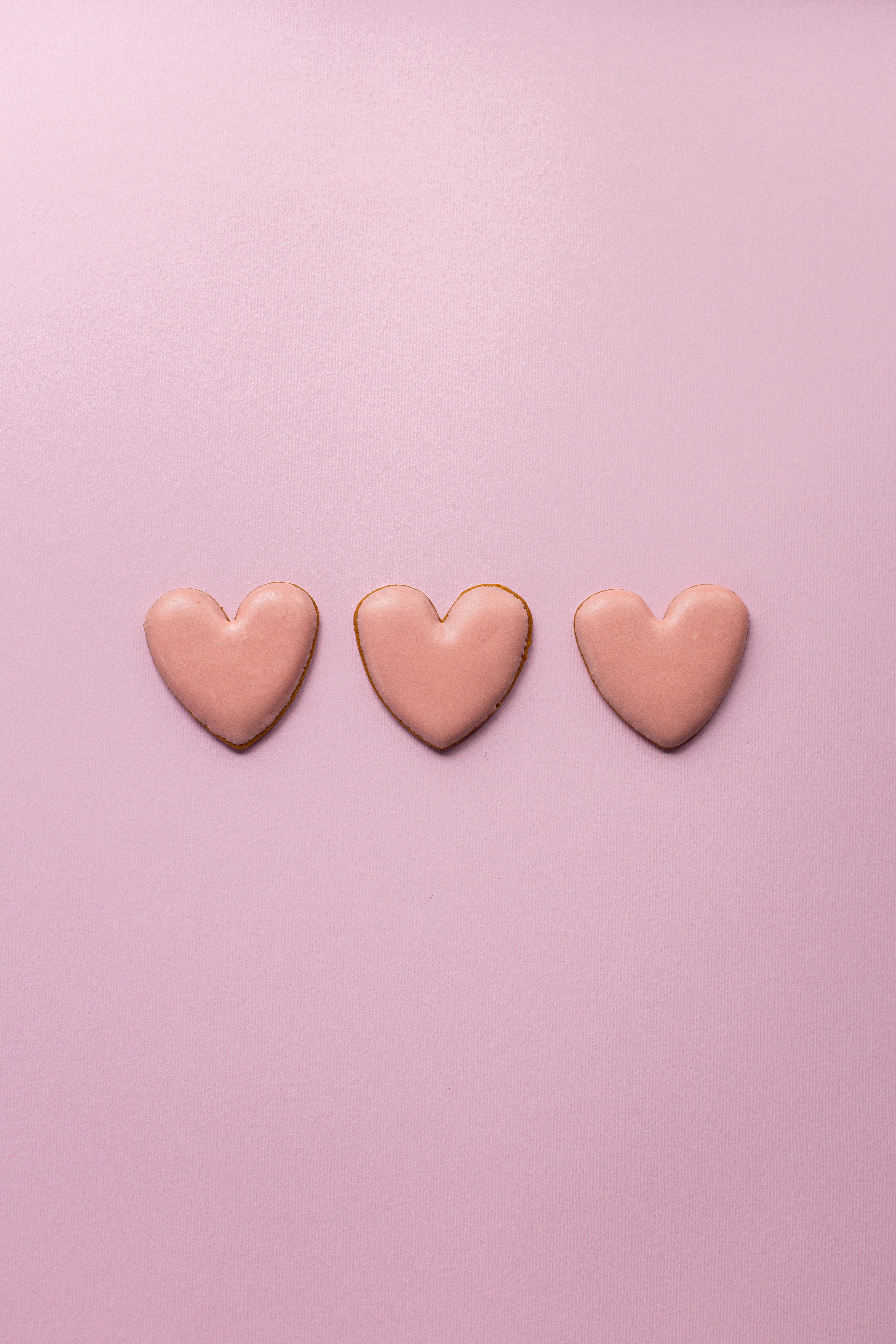 Small heart cookies on pink surface · Free