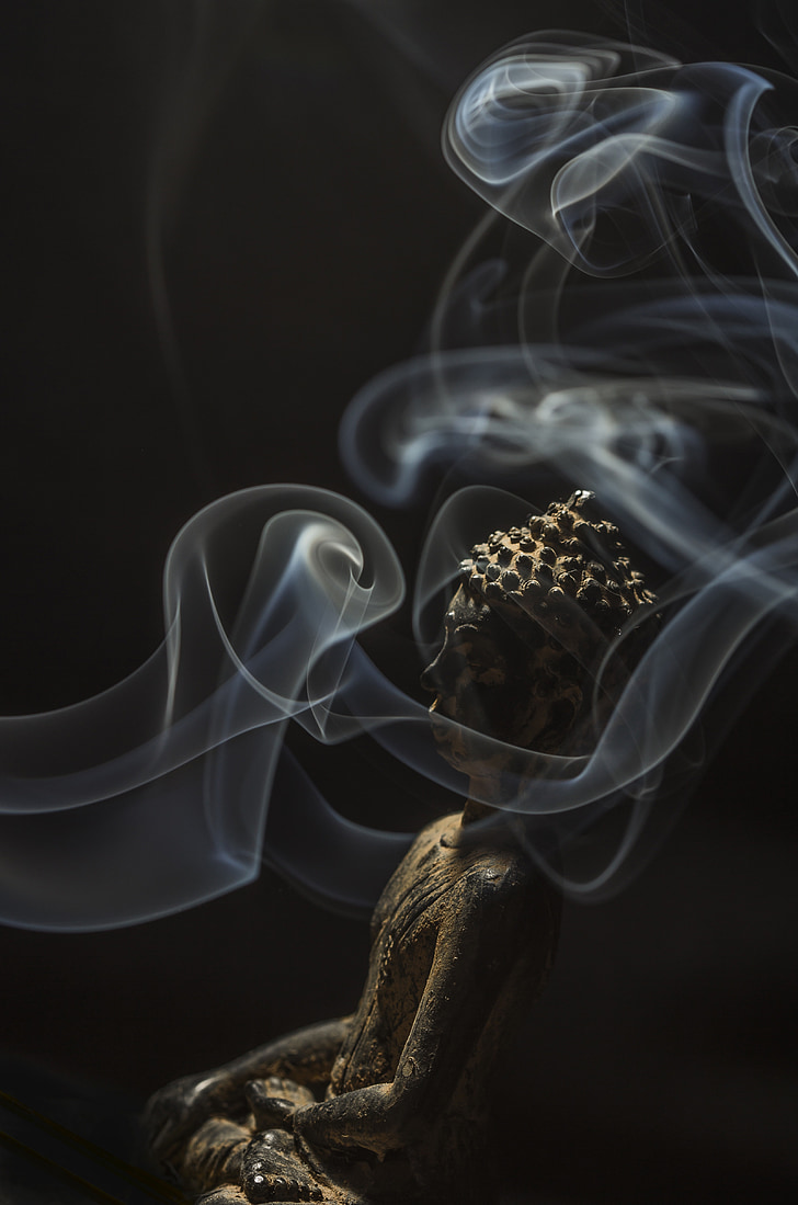 Royalty Free Photo: Gautama Buddha Figurine Surrounded With Smoke
