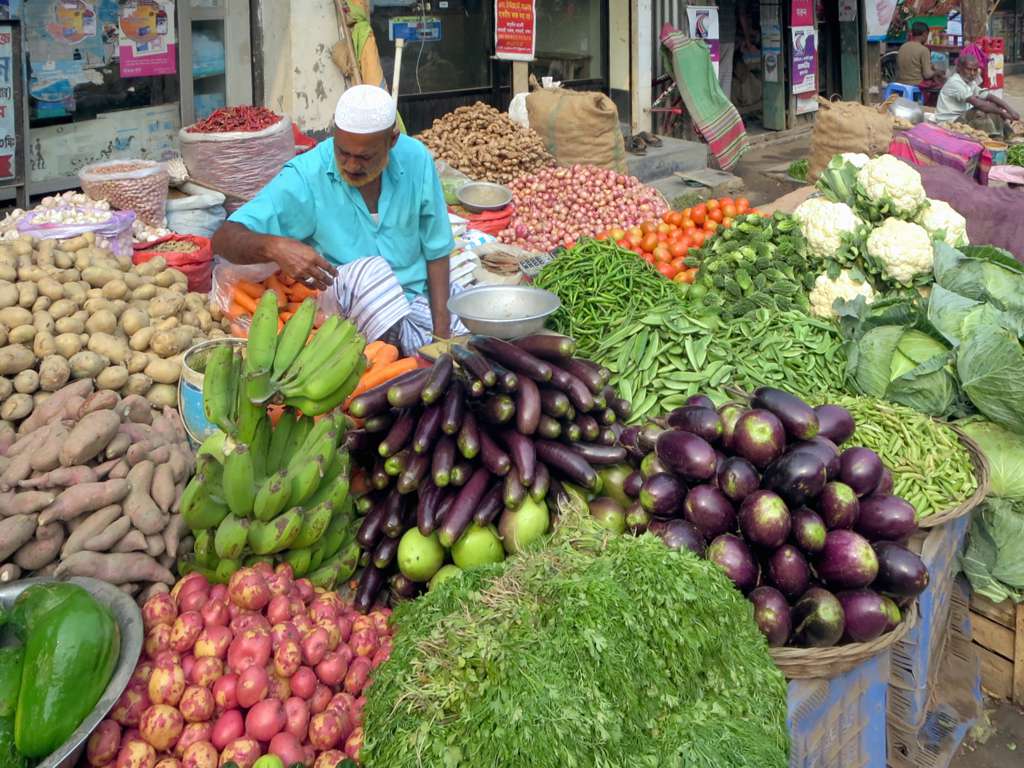 Dhamrai Vegetable Vendor. A vegetable vendor waits on the m