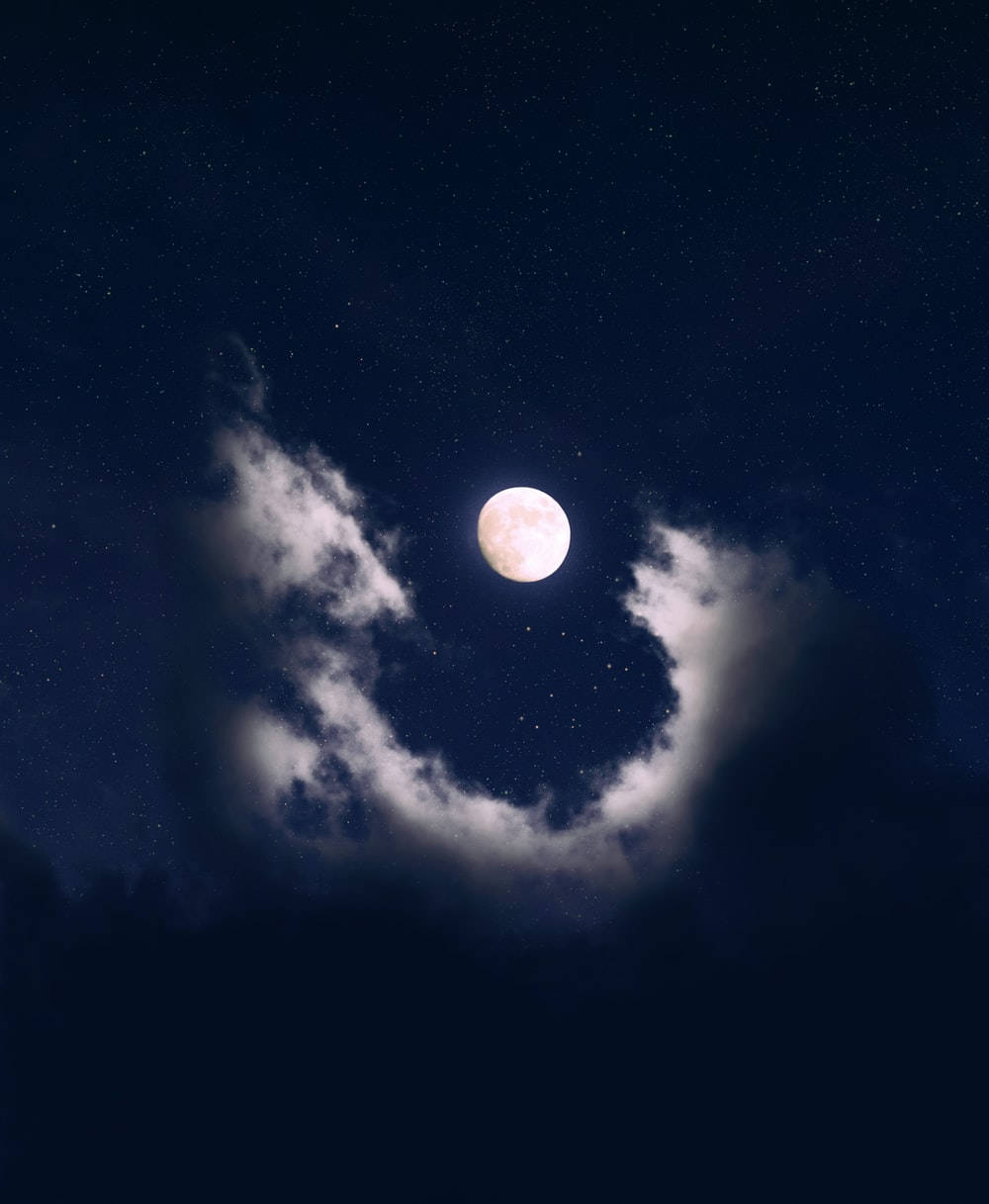 Download Aesthetic Clouds Surrounding The Moon Wallpaper