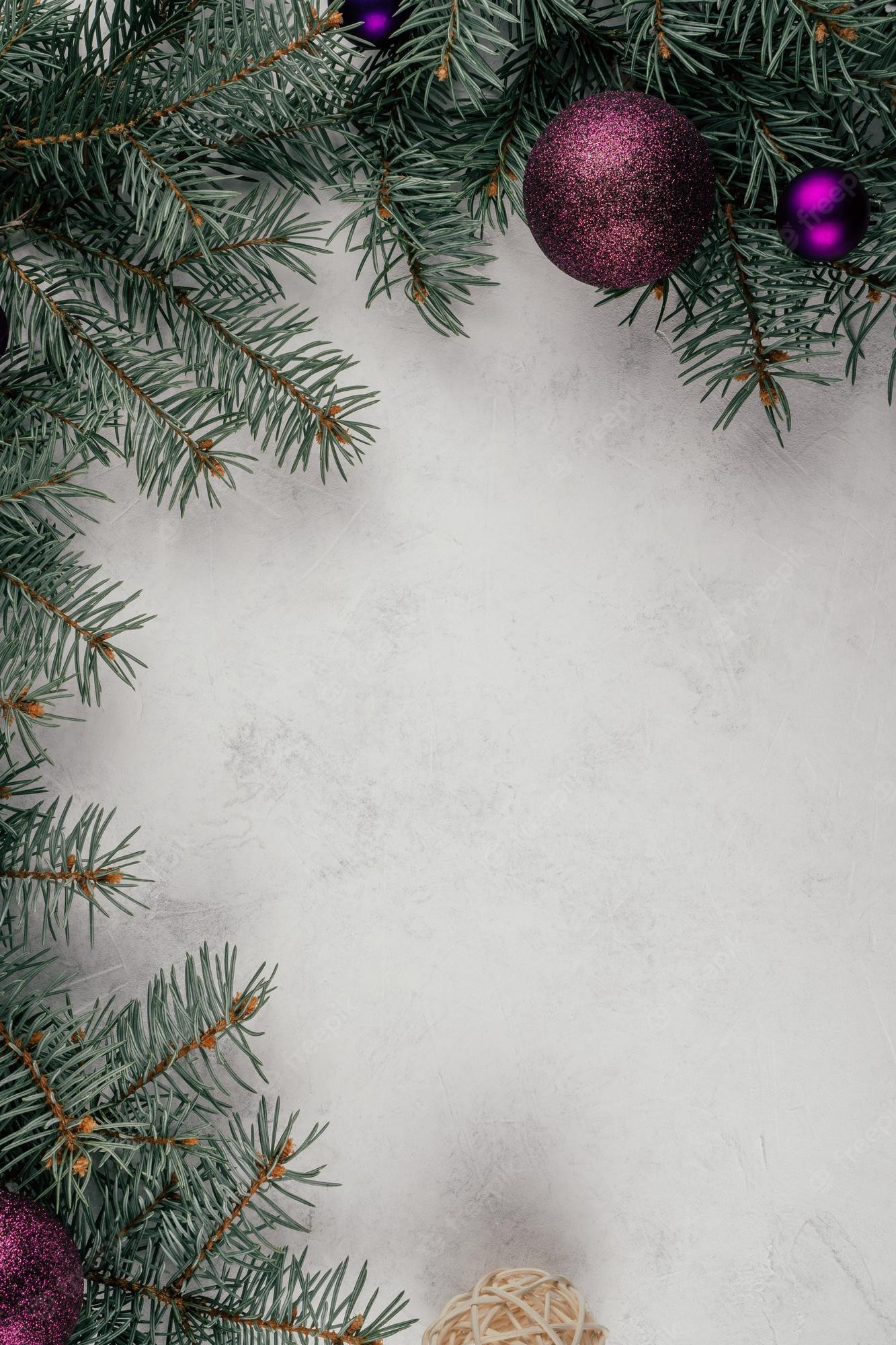 Premium Photo. Background image of white surface with branches of christmas tree, decorations and purple balls. vertical. copy space