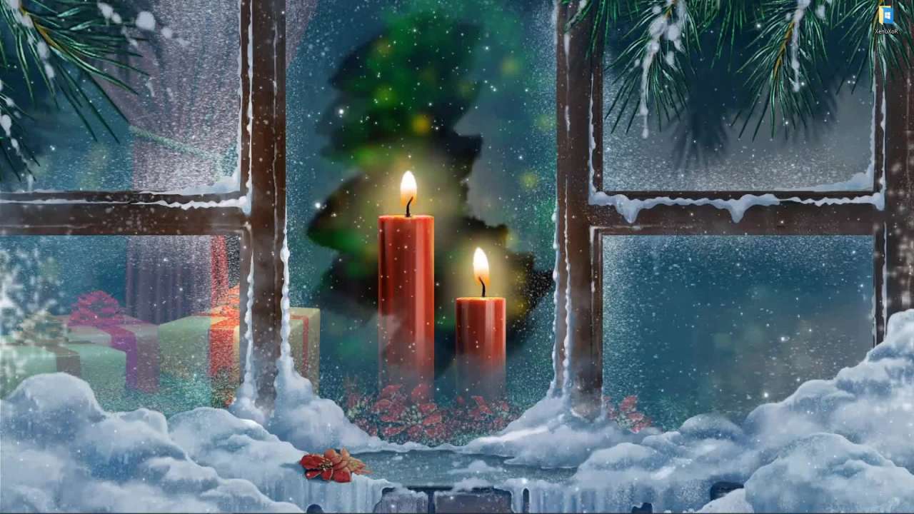 Two candles outside the Christmas window live wallpaper on desktop