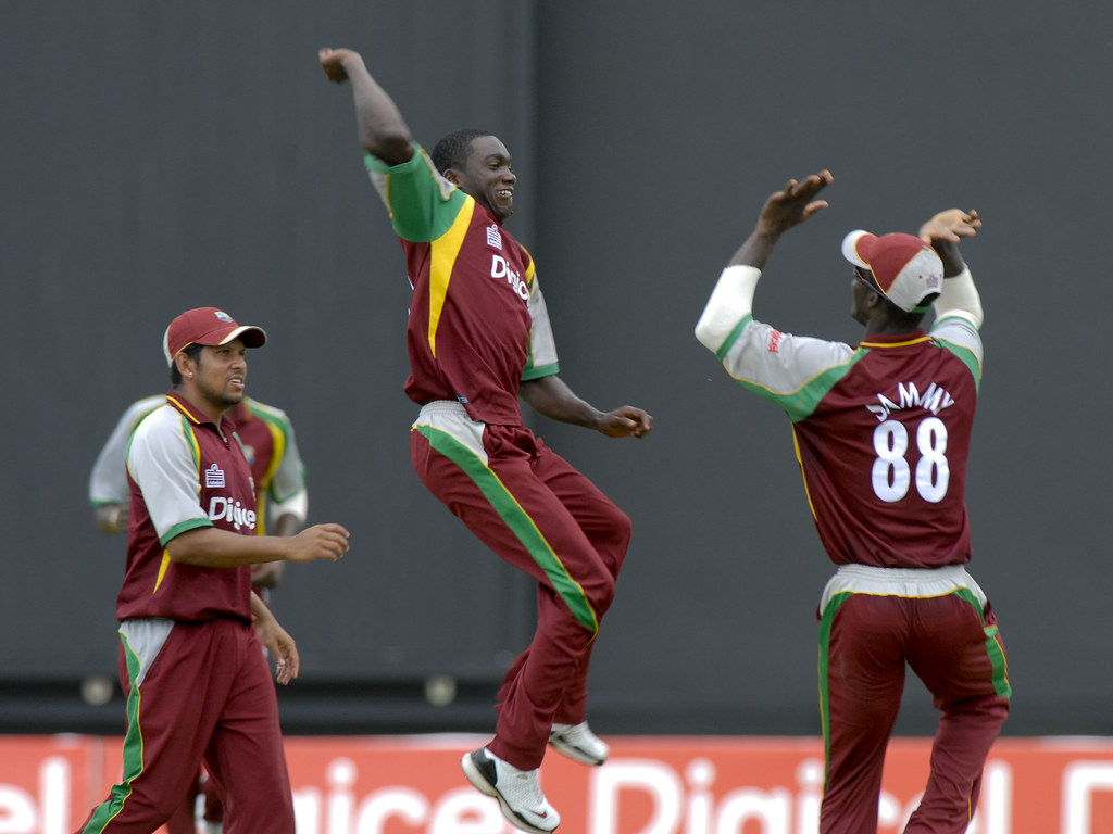 Jerome Taylor and Darren Sammy celebrate Ricky Ponting's w