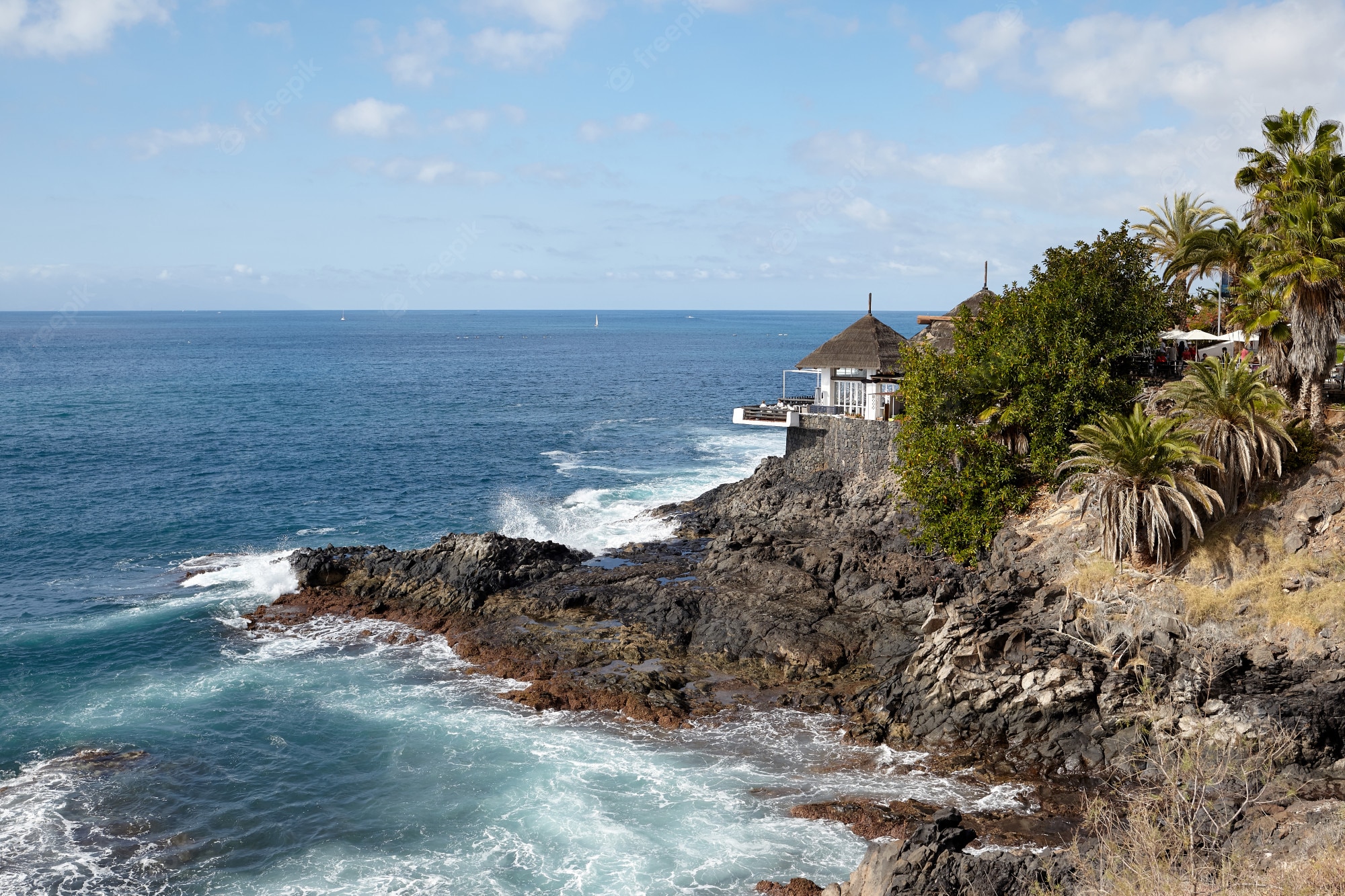Premium Photo. View of a beautiful house on the rocks and ocean