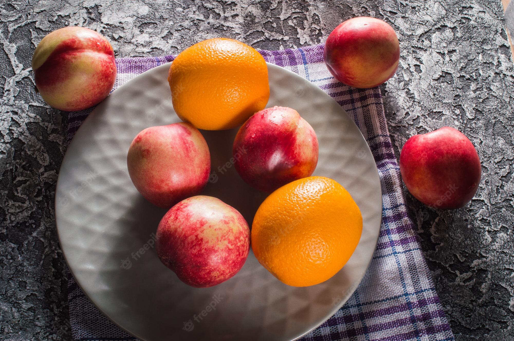 Premium Photo. Background of bright and ripe nectarines in full screen autumn wallpaper of exotic southern fruits the concept of harvesting