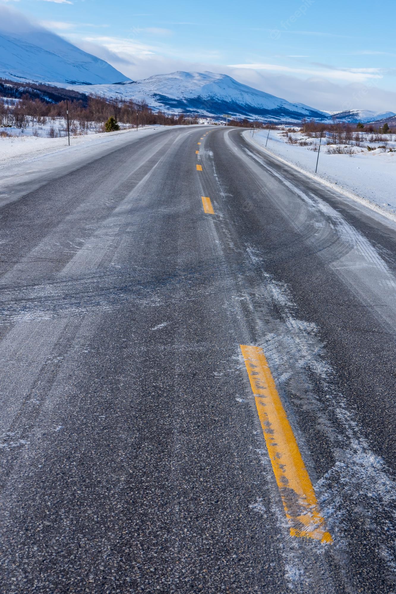 Free Photo. Beautiful view of the frozen road on a cold winter day in norway