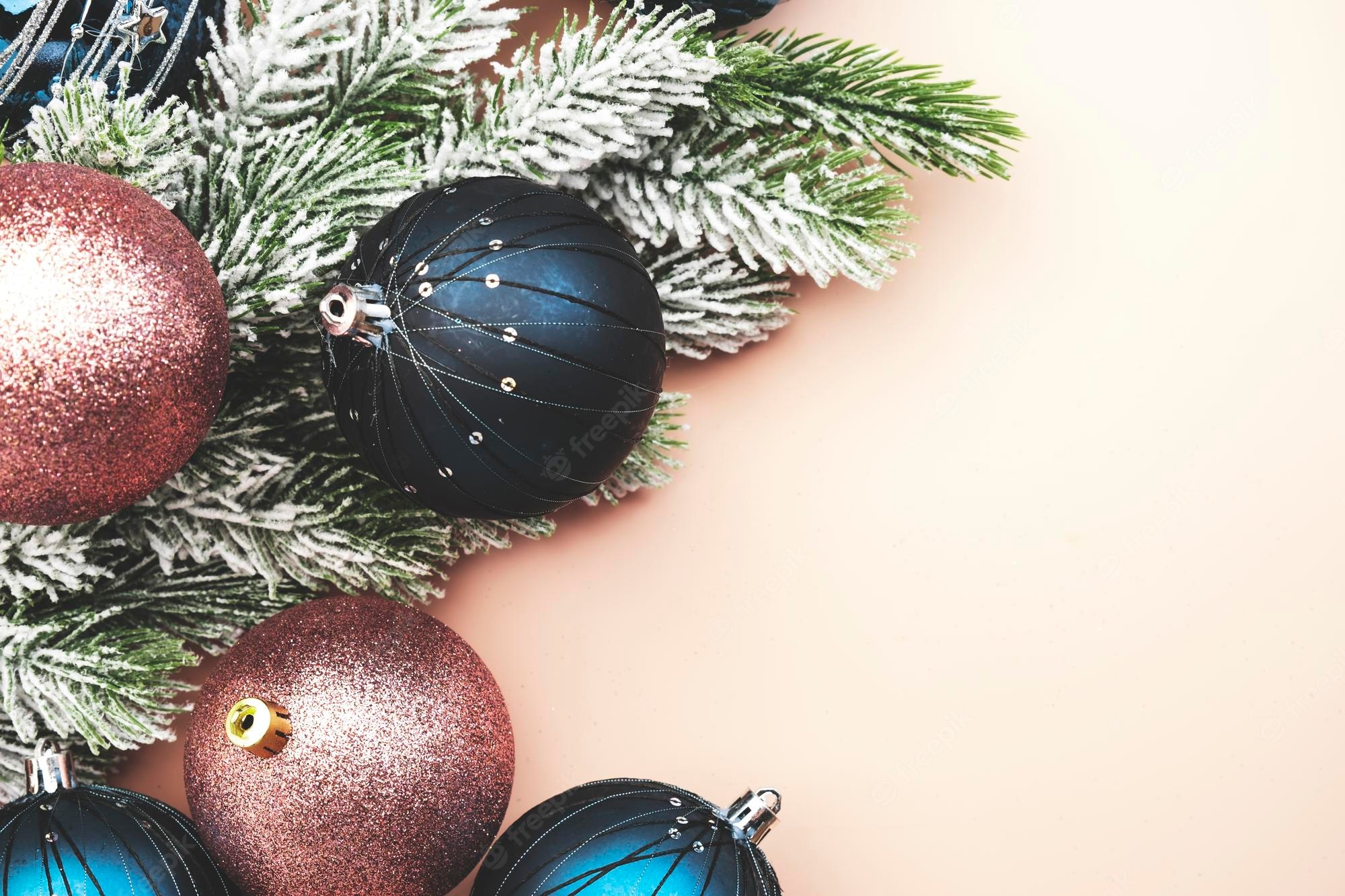 Premium Photo. Merry christmas and happy new year pastel background with blue and pink christmas balls with golden greeting text banner top view