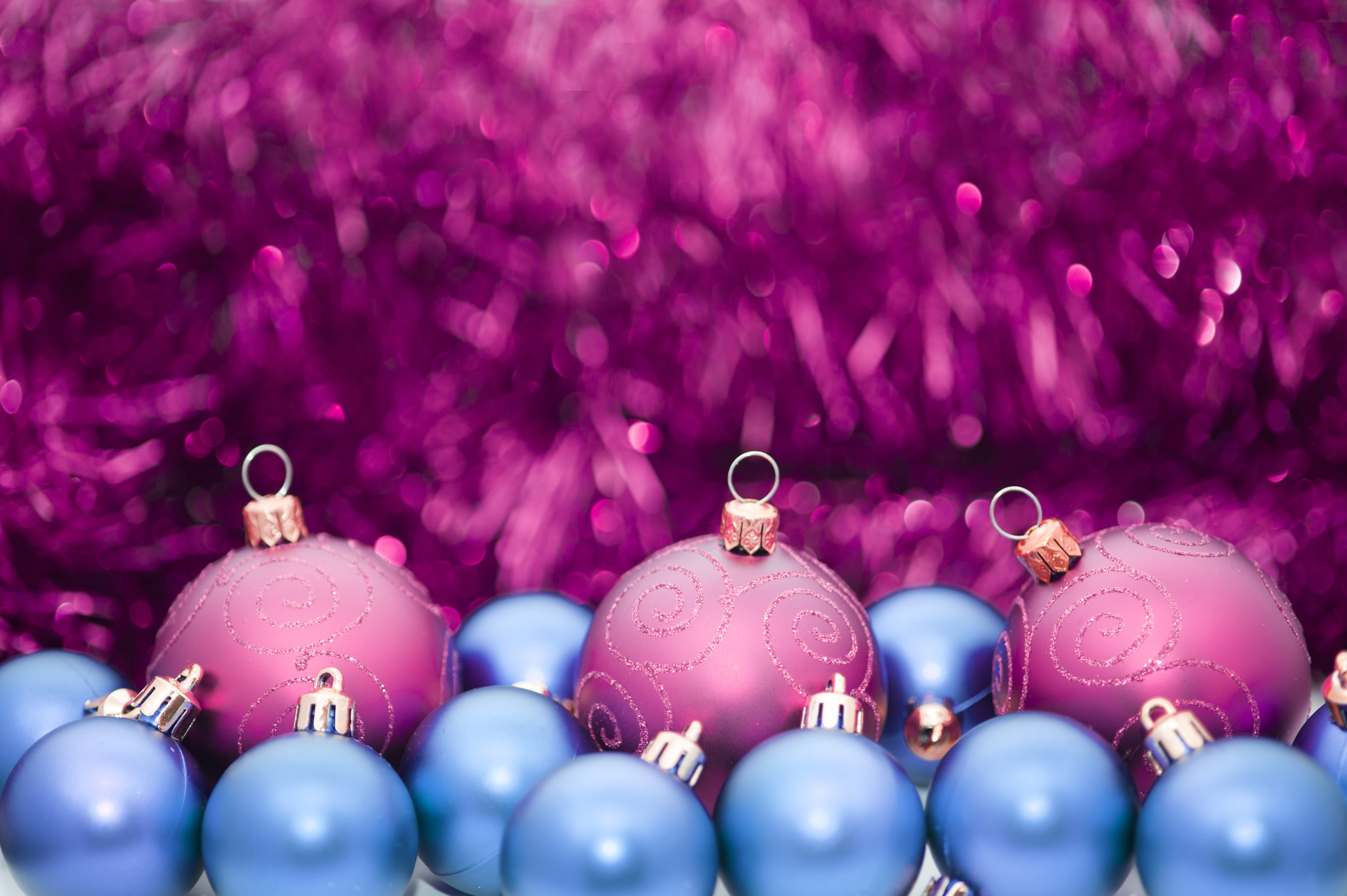 Photo of purple tinsel bauble background. Free christmas image