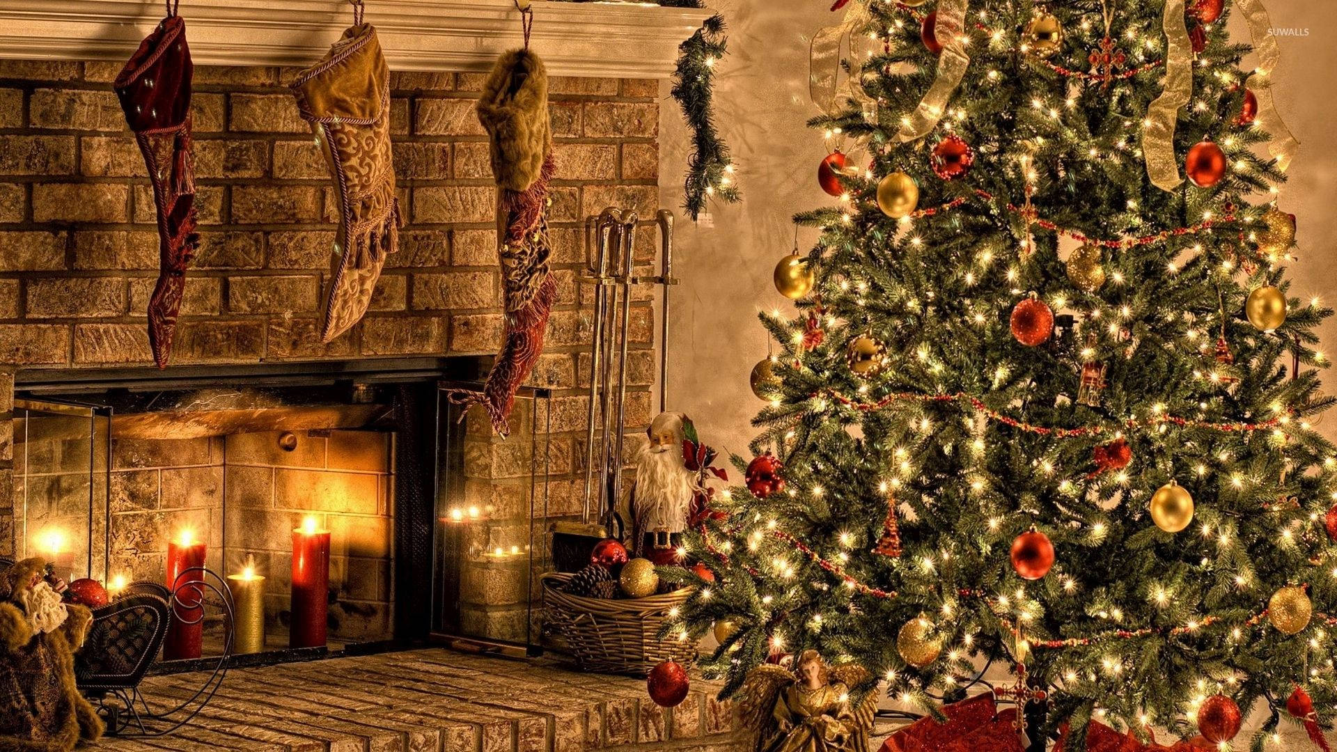 Download Red Gold Christmas Tree By The Fireplace Wallpaper