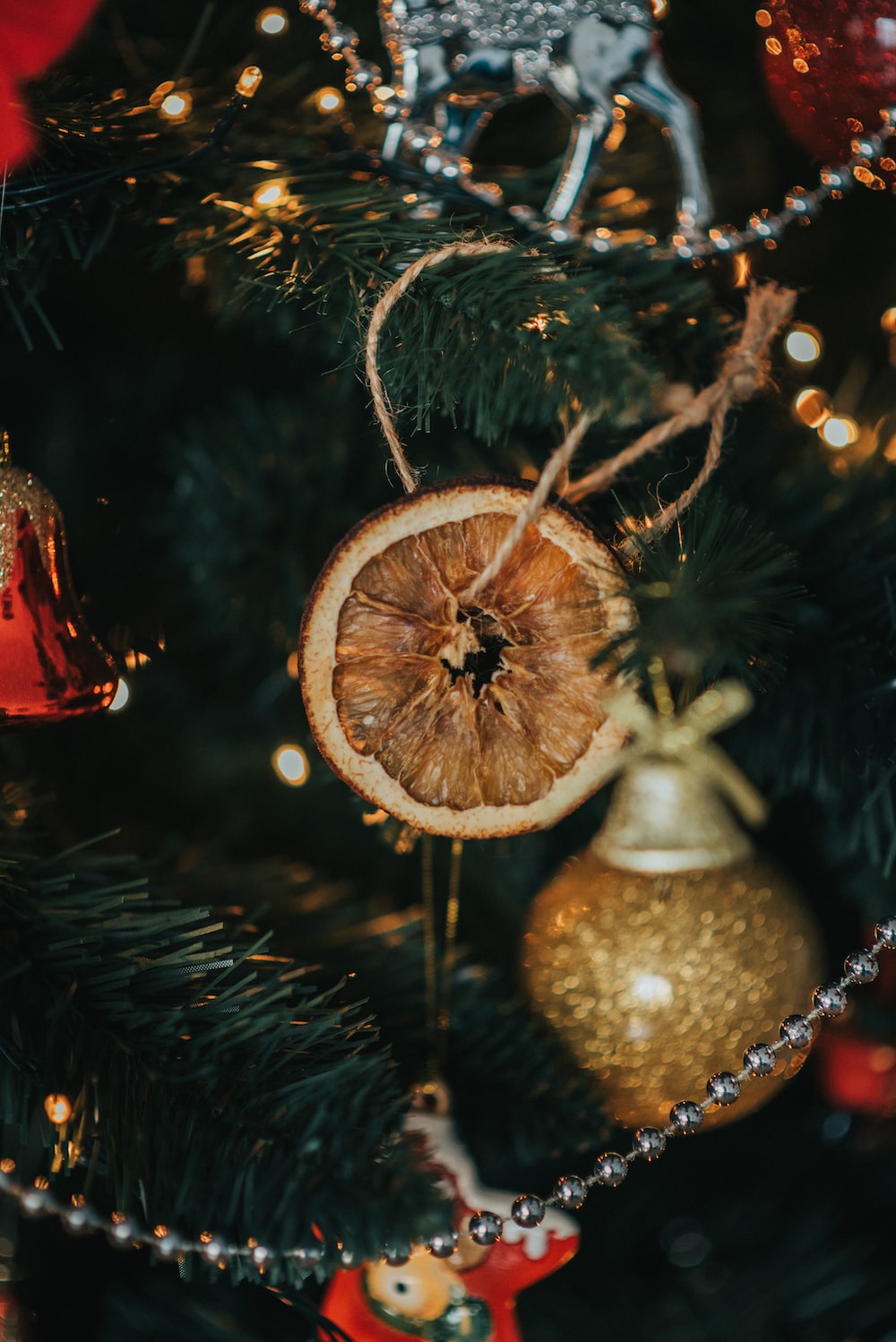 gold and red baubles on green christmas tree photo