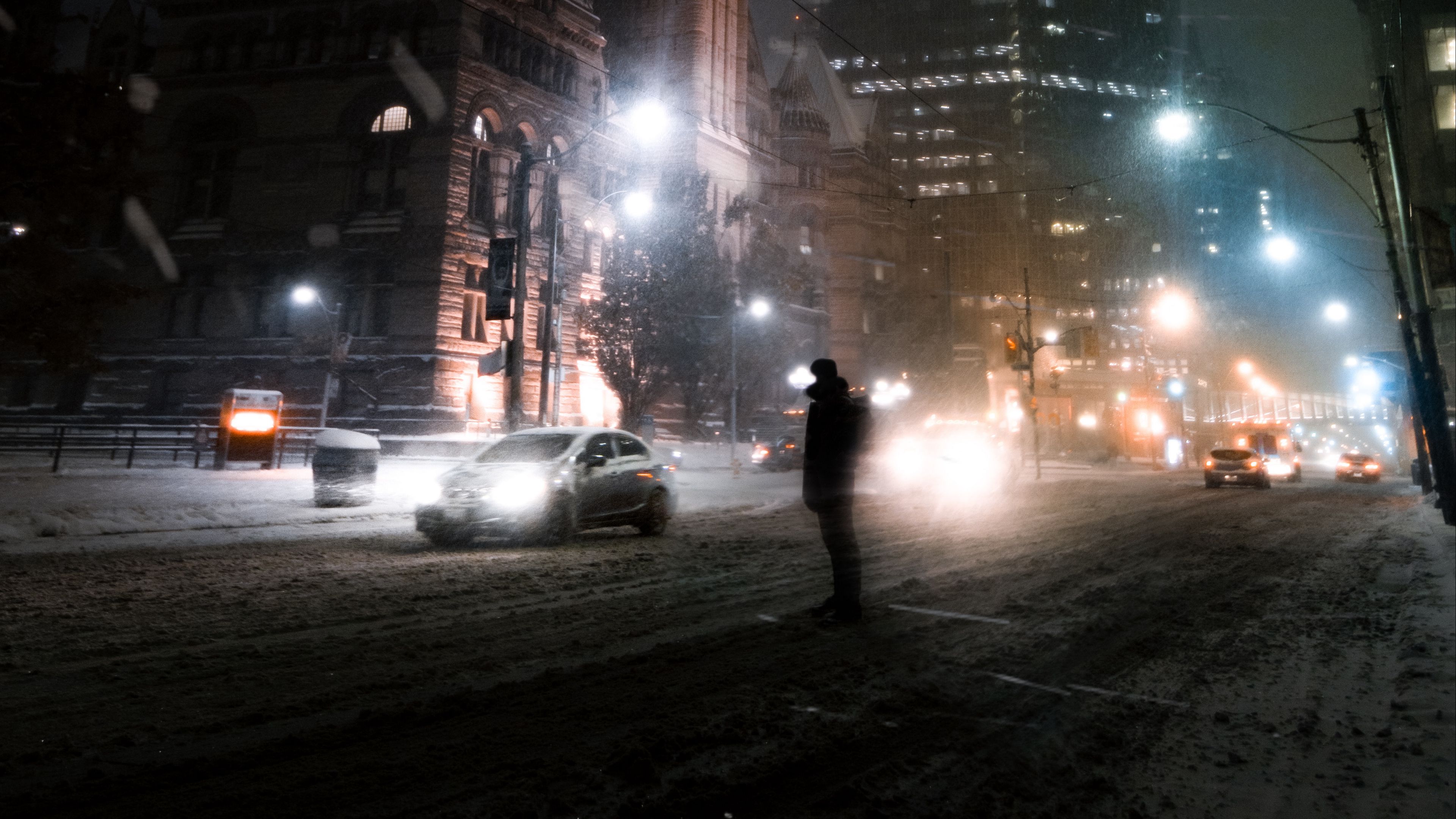 Download wallpaper 3840x2160 silhouette, night city, snowfall, street, city lights 4k uhd 16:9 HD background