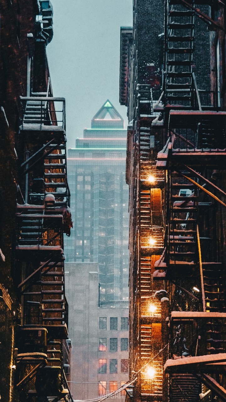 view through an alley of apartment stairwells of a skyscraper downtown in the winter, vertical landscape, Oppo A12s background, 720x1520 Gallery HD Wallpaper