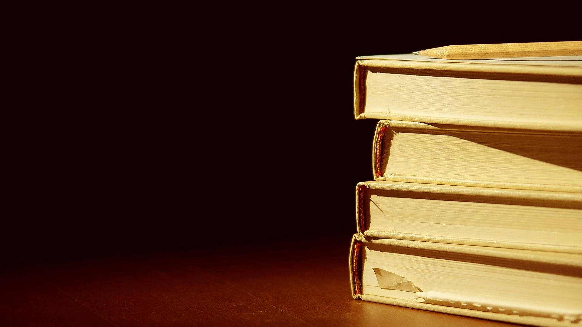 Download Dramatic Stack Of Books Wallpaper