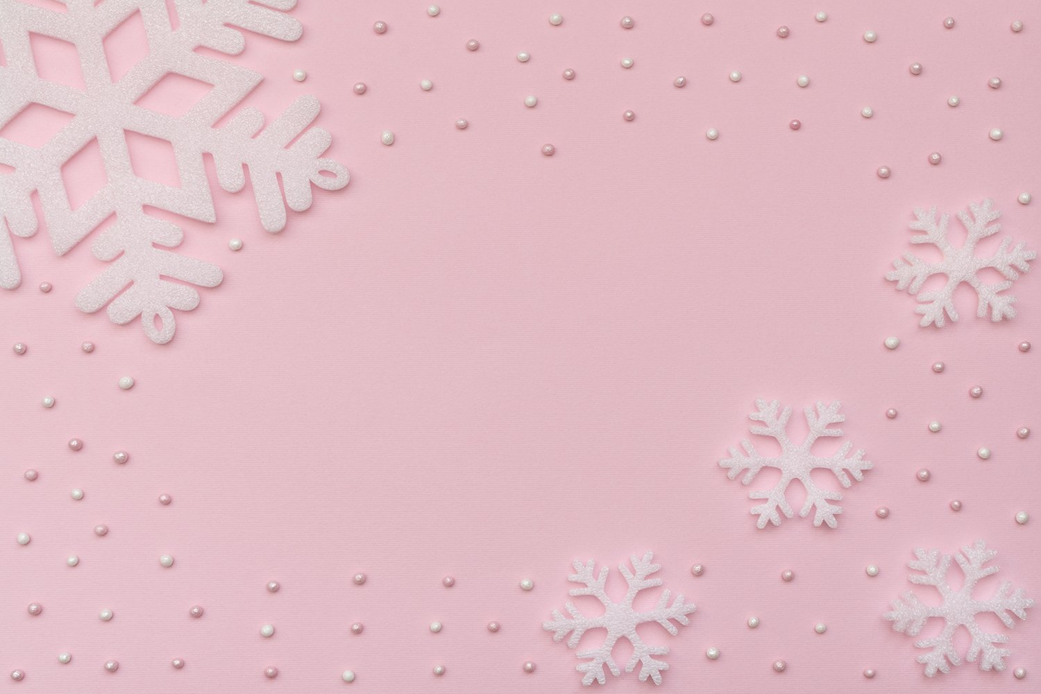 Christmas pink background with white snowflakes