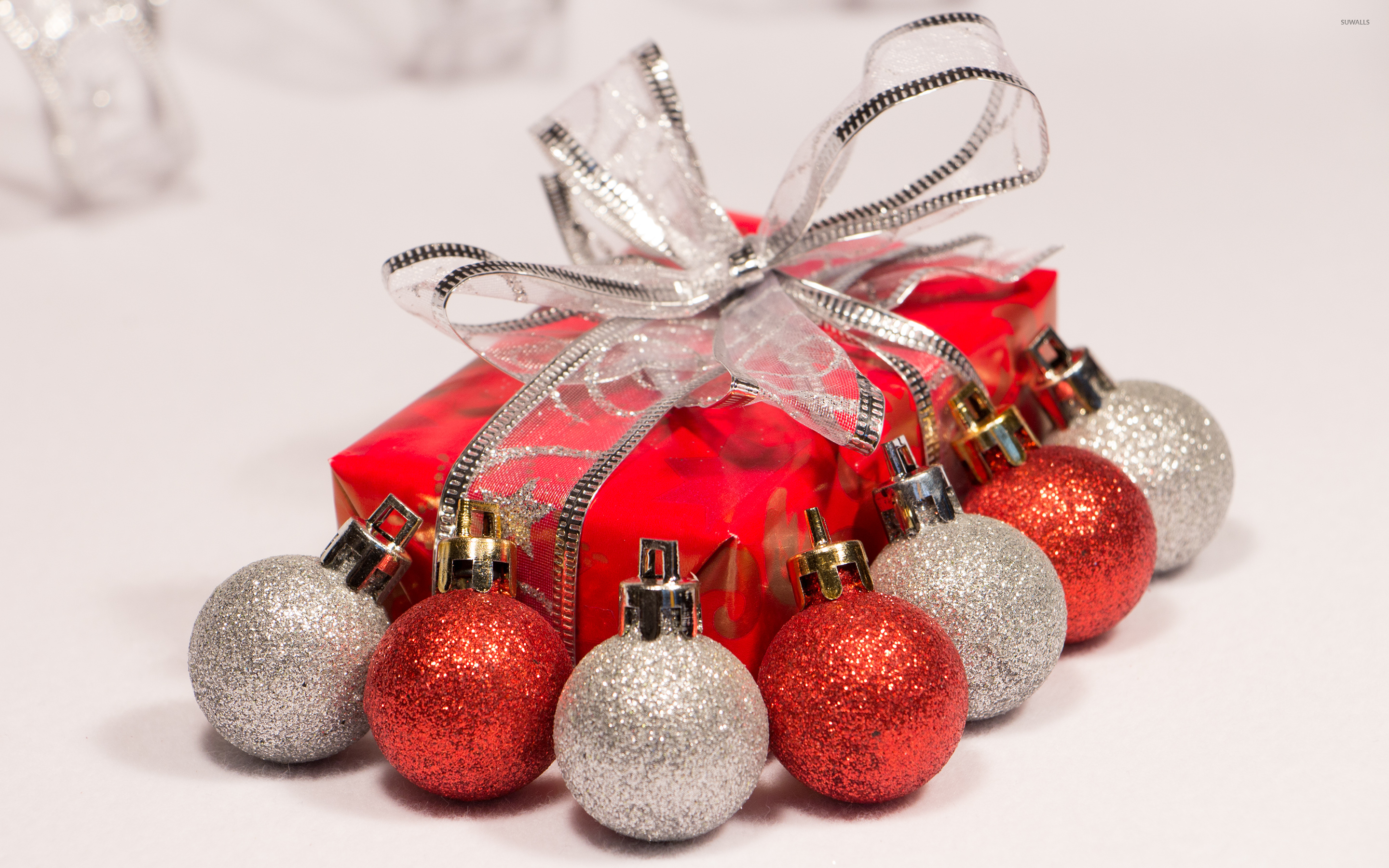 Red and silver baubles by the Christmas present wallpaper wallpaper