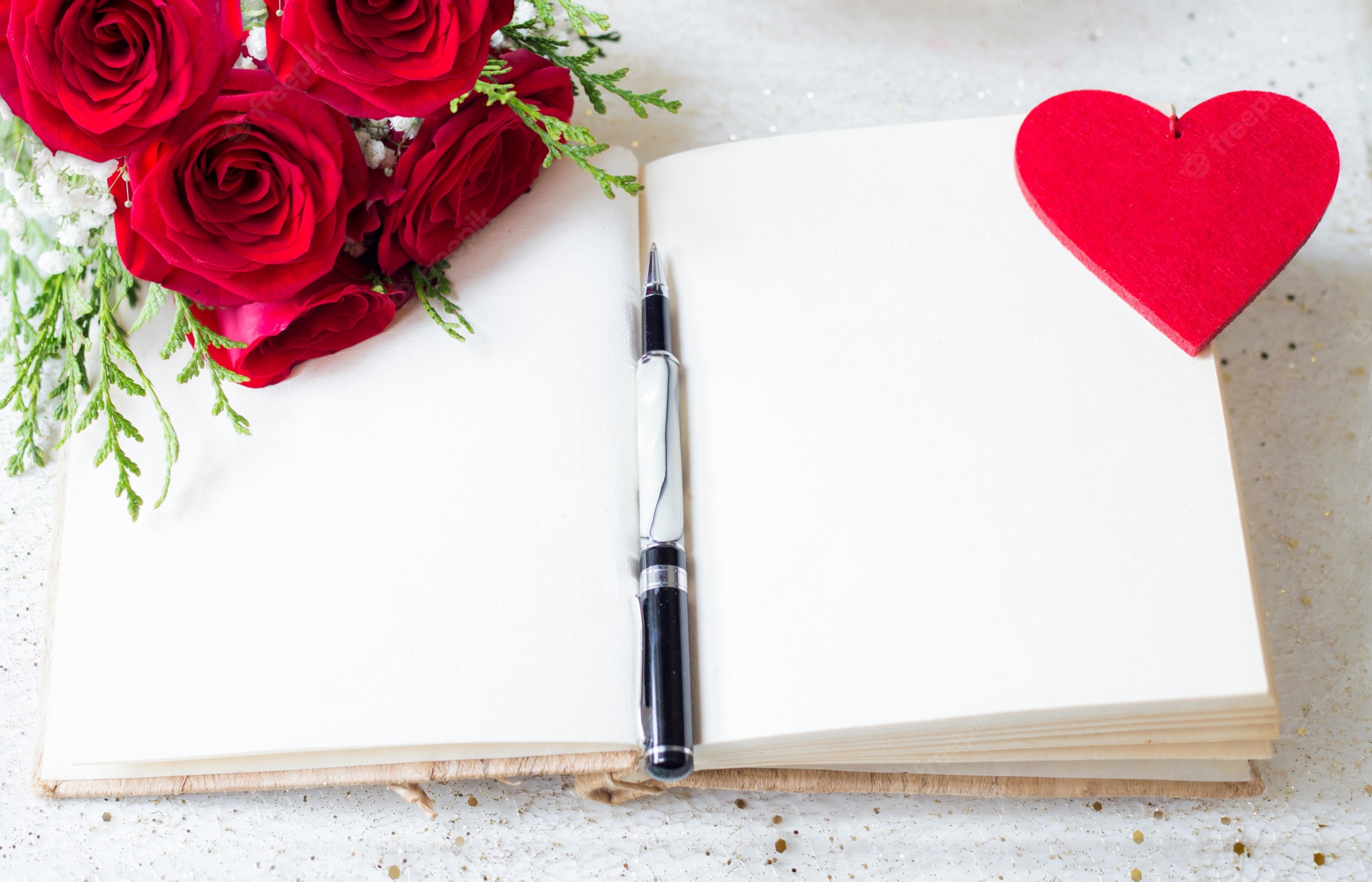 Premium Photo. Open book with blank pages and pen over and red roses and felt heart background