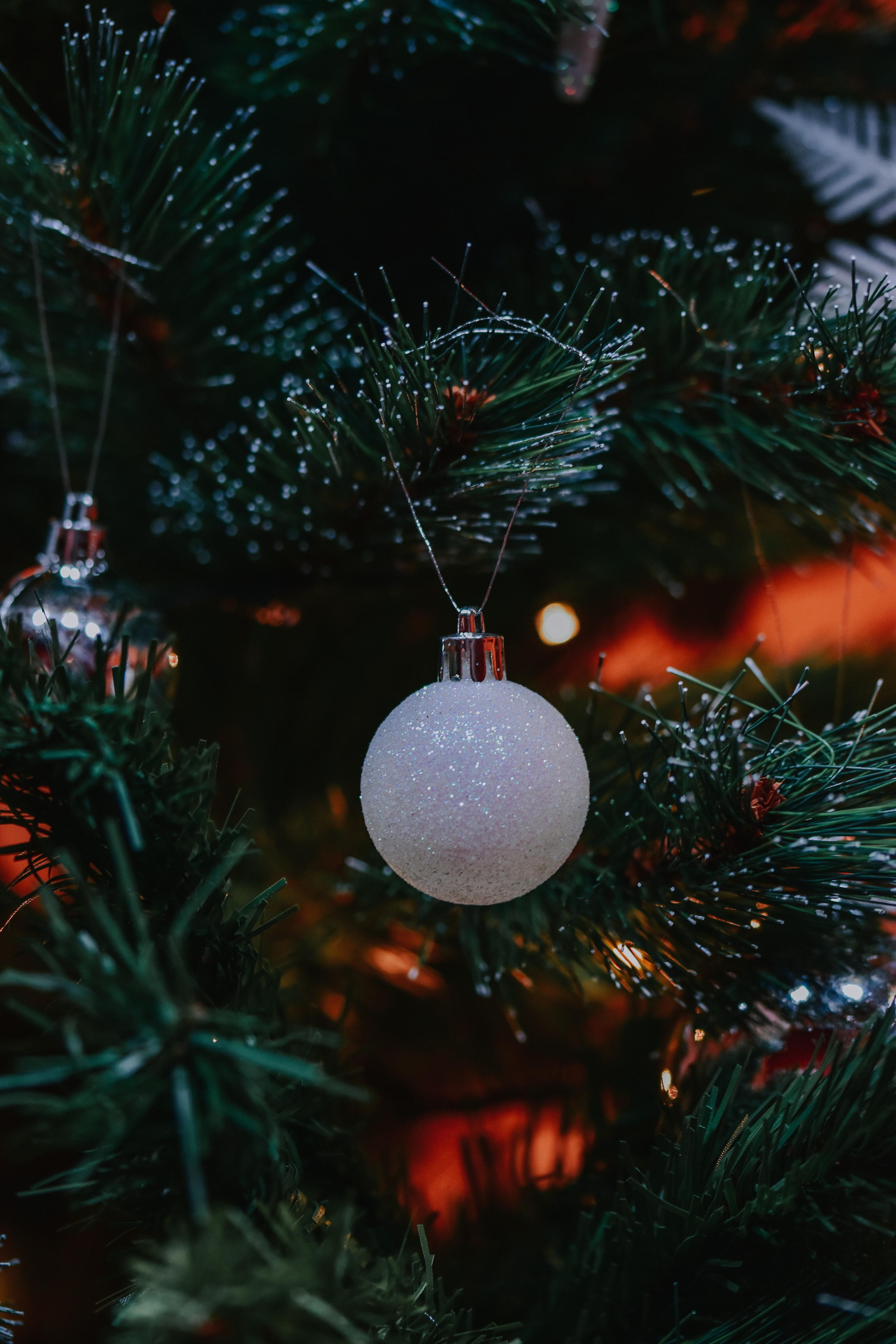 White Christmas decoration hanging on Christmas tree · Free