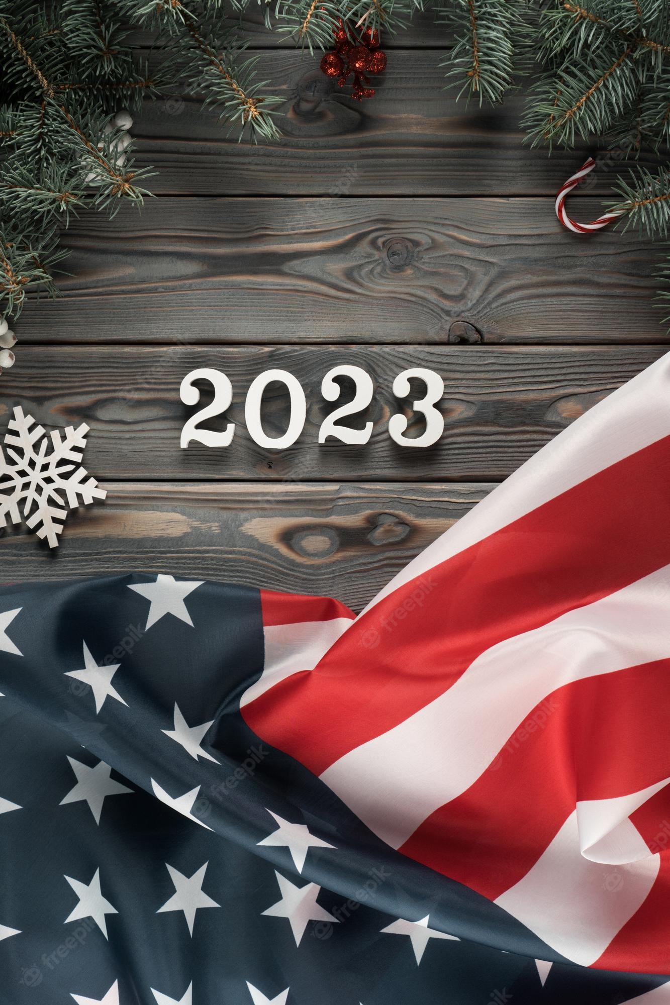 Premium Photo. Vertical dark wooden wallpaper with american flag 2023 and christmas toy frame decoration happy new year and merry xmas