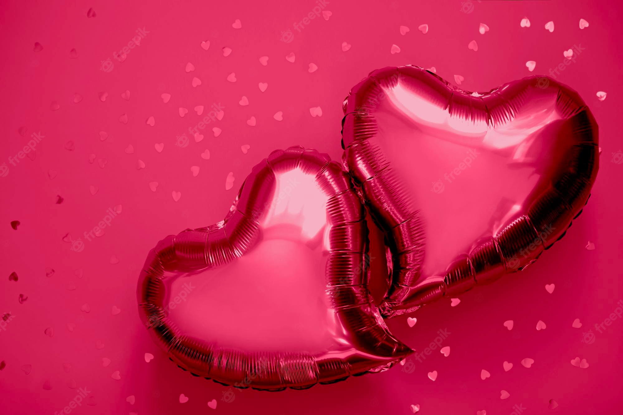 Premium Photo. Two Heart Shaped Foil Balloons On The Background Of New Color Of 2023 Year Red Viva Magenta