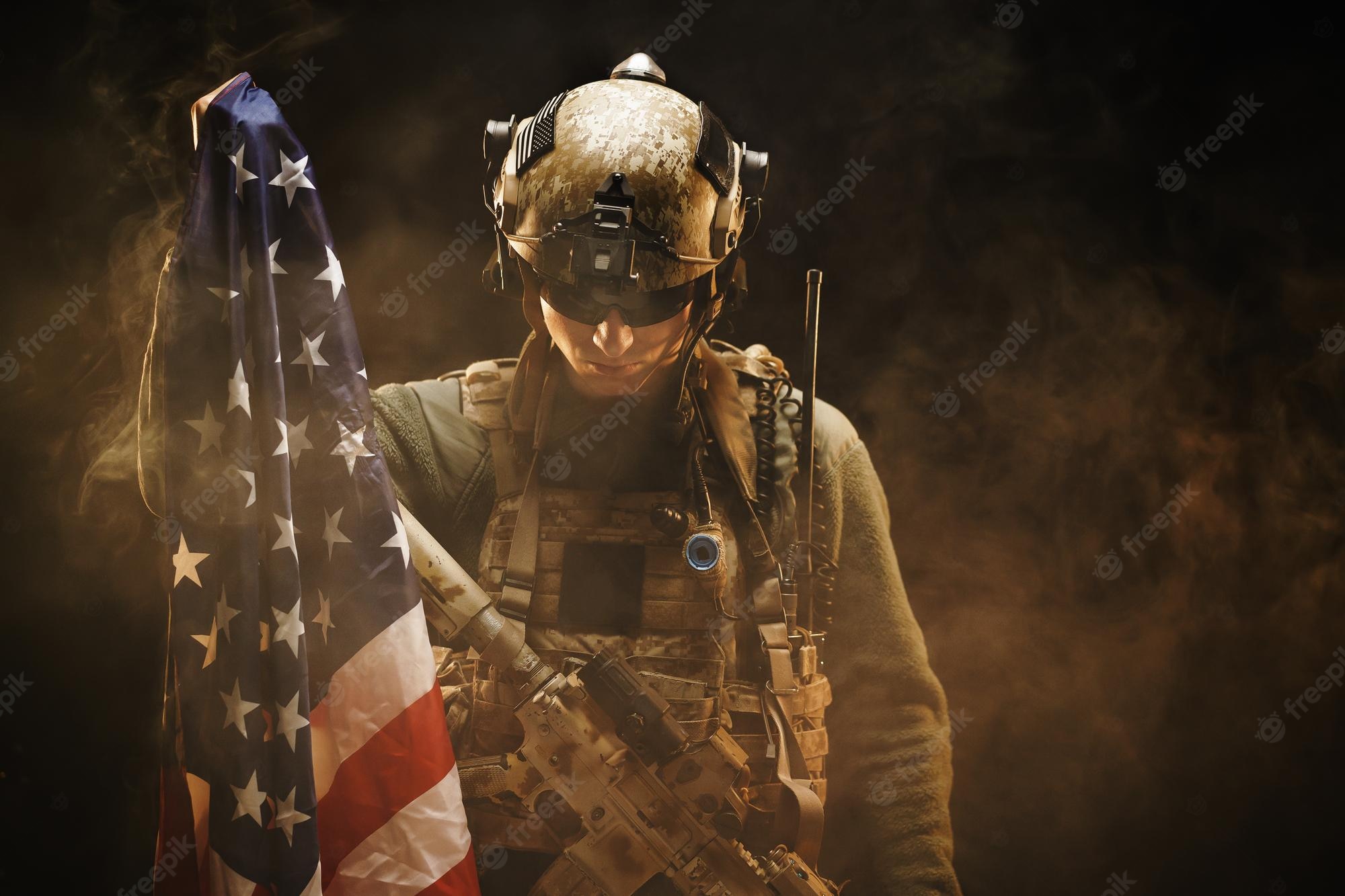 Premium Photo. Special forces soldier holding us national flag in the dark