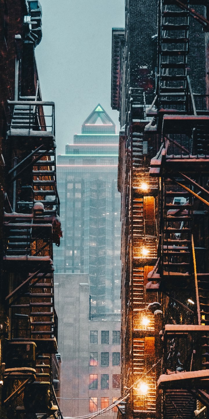 view through an alley of apartment stairwells of a skyscraper downtown in the winter, vertical landscape, BLU Studio View XL full HD wallpaper, 720x1440 Gallery HD Wallpaper