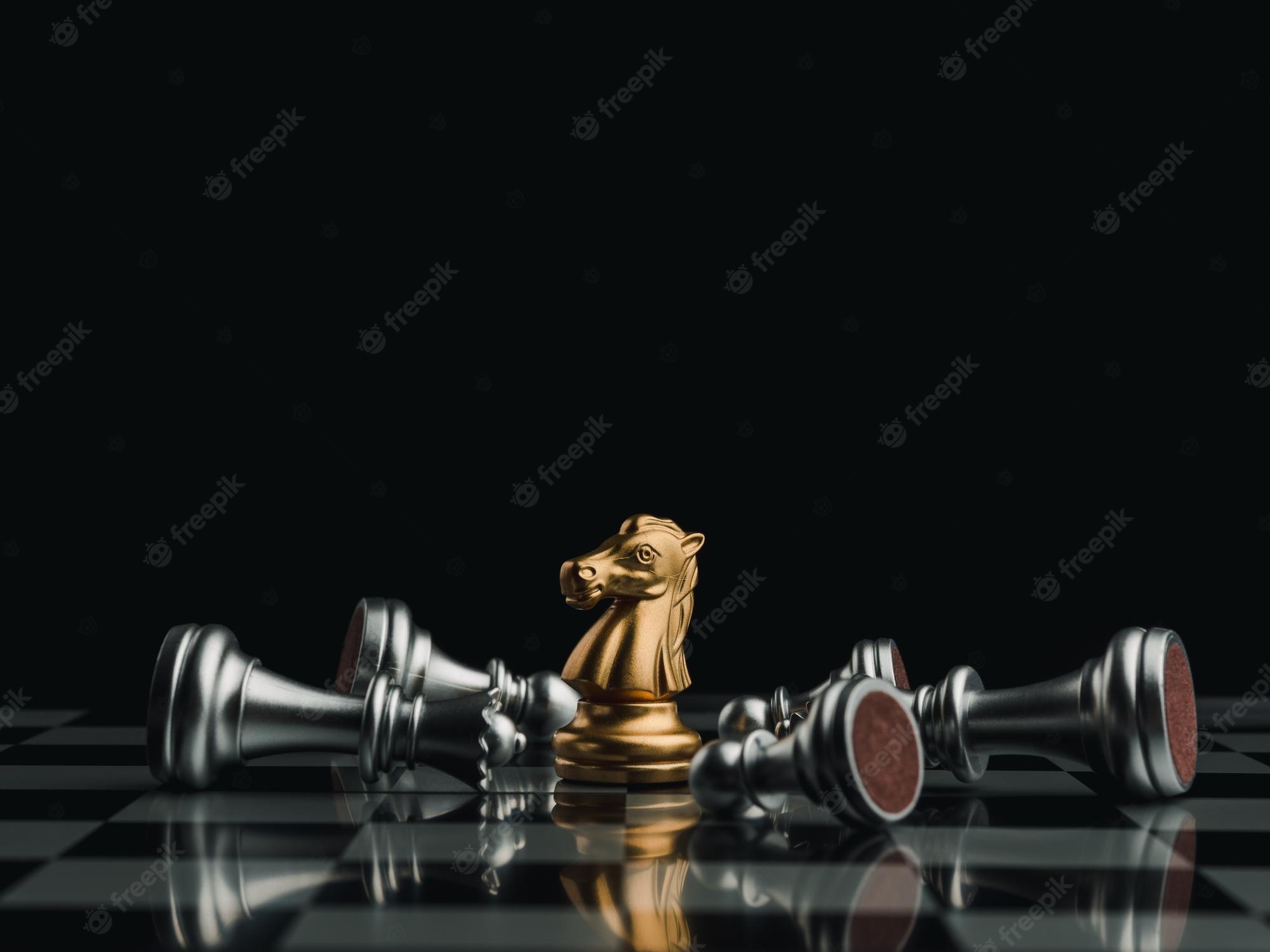 Premium Photo. The gold horse, knight chess piece standing with falling silver pawn chess pieces on chessboard on dark background. leadership, winner, competition, and business strategy concept
