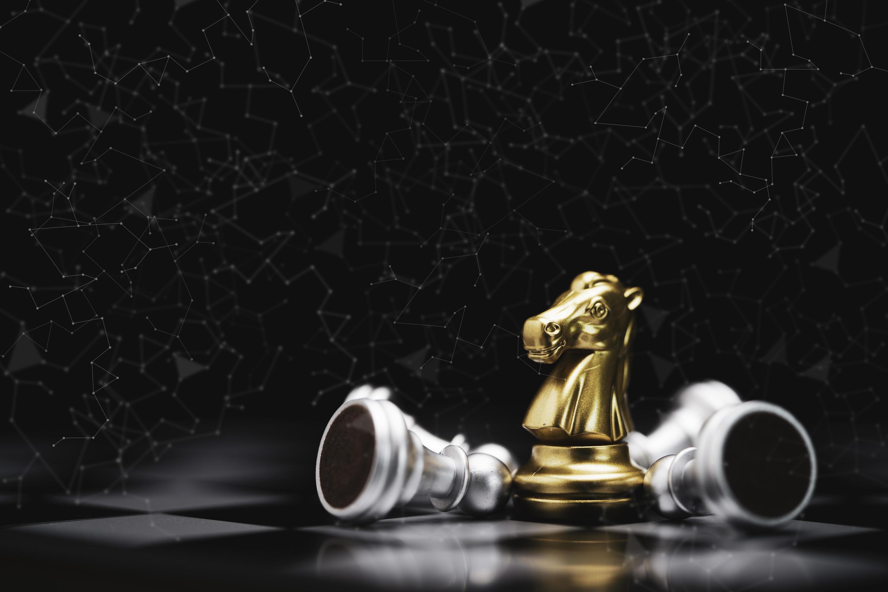 Closeup golden horse or knight chess with falling pawn chess on dark background for winner business with competitor and strategy concept