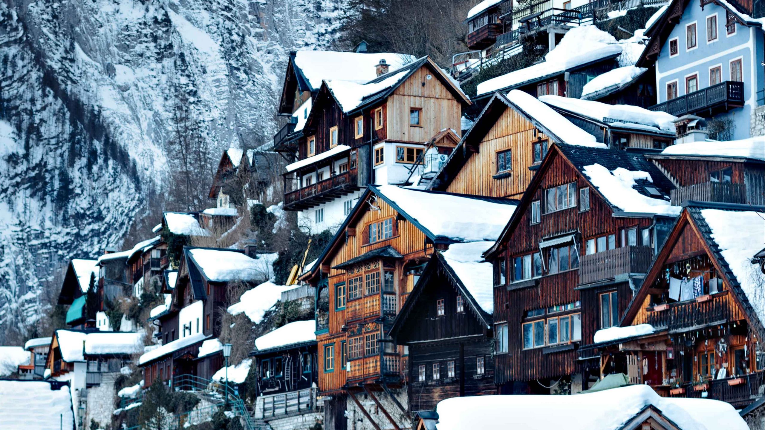 Download wallpaper 2560x1440 village, buildings, snow, nature, winter widescreen 16:9 HD background