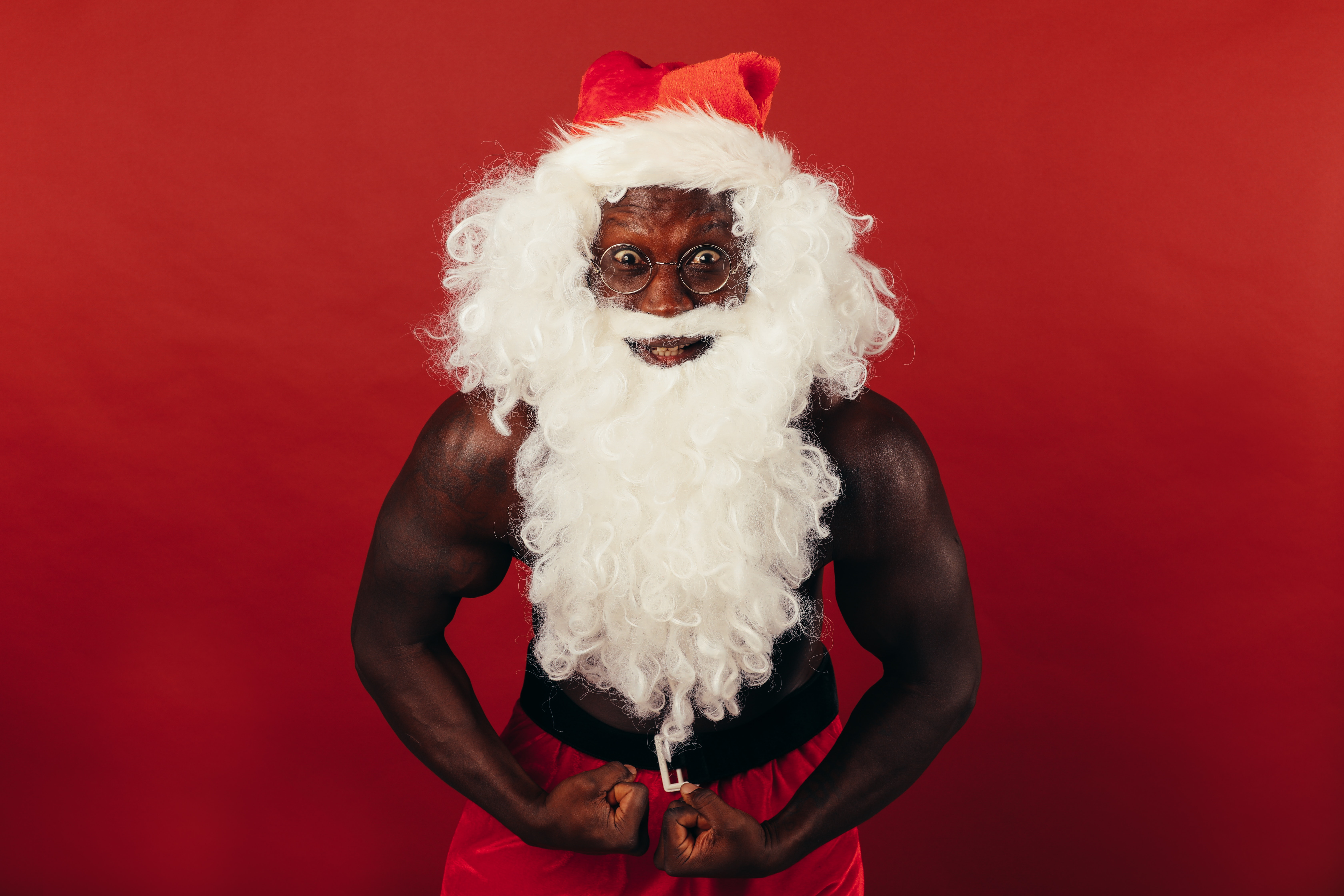 Black Man With Muscular Body Wearing A Santa Costume · Free