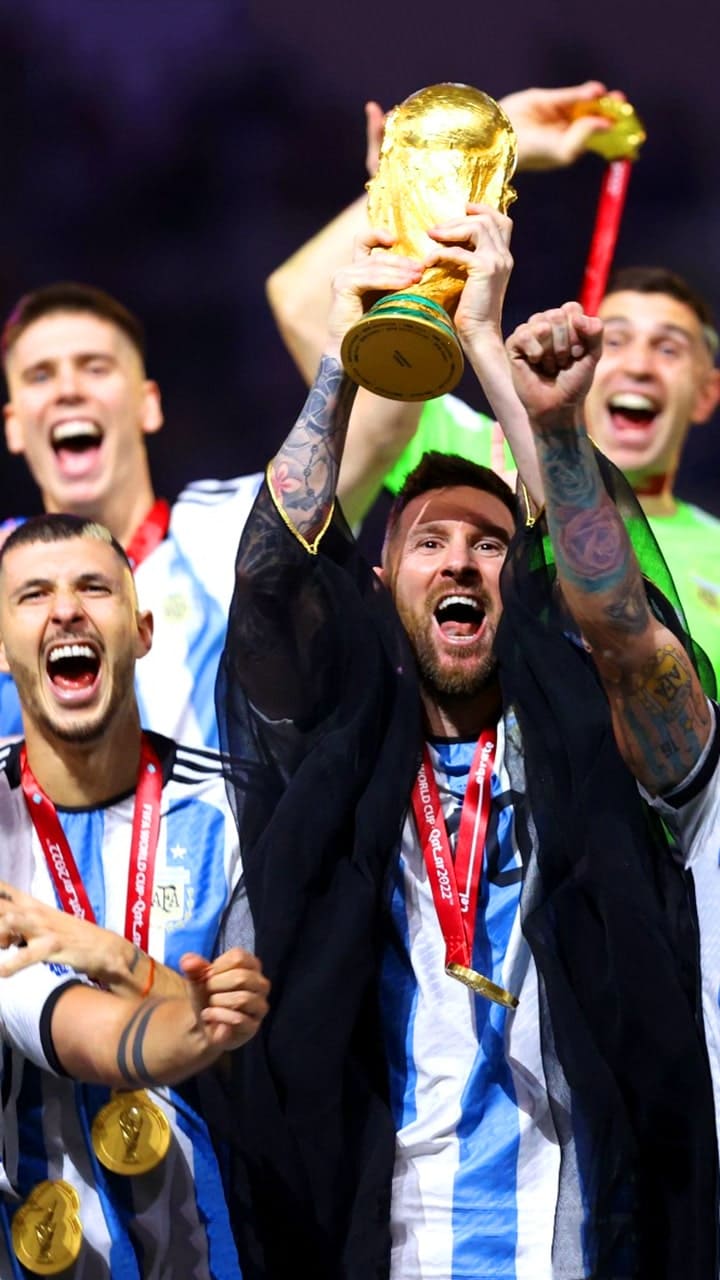 He smiled he paused he hoisted  Messi lifts World Cup after final for  the ages