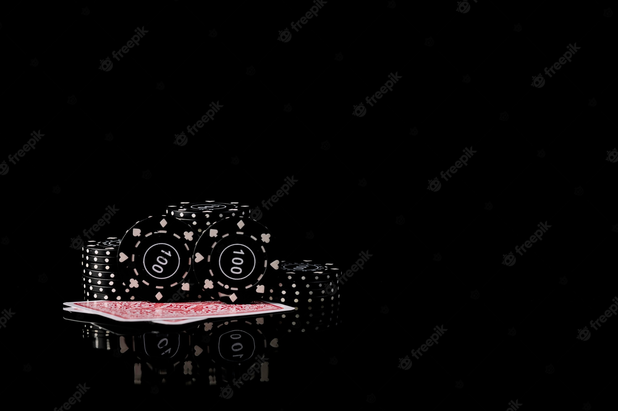 Premium Photo. Playing cards and poker chips on black background