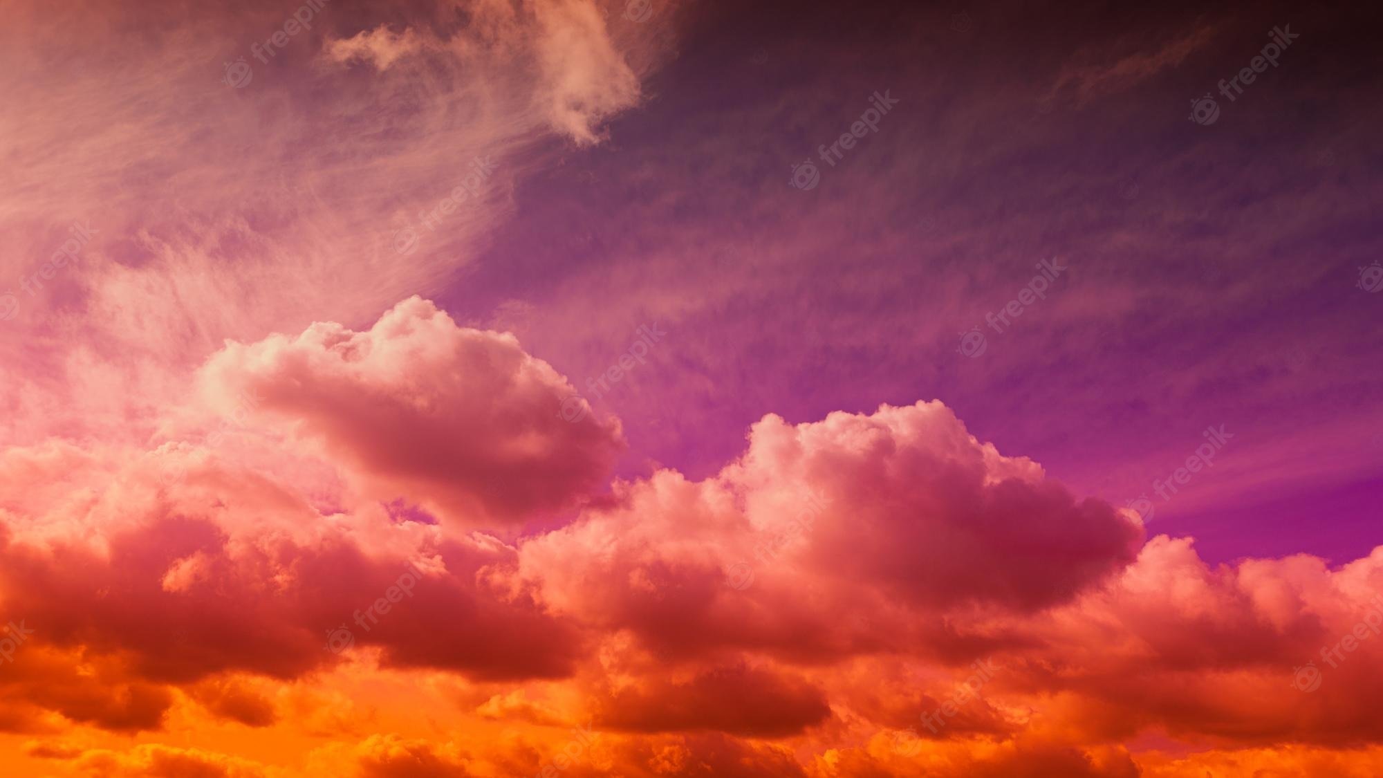 Premium Photo. Beautiful vivid coral purple orange sky wallpaper at sunset with clouds darmatic sunshine sky beautiful view evening clouds fast moving away