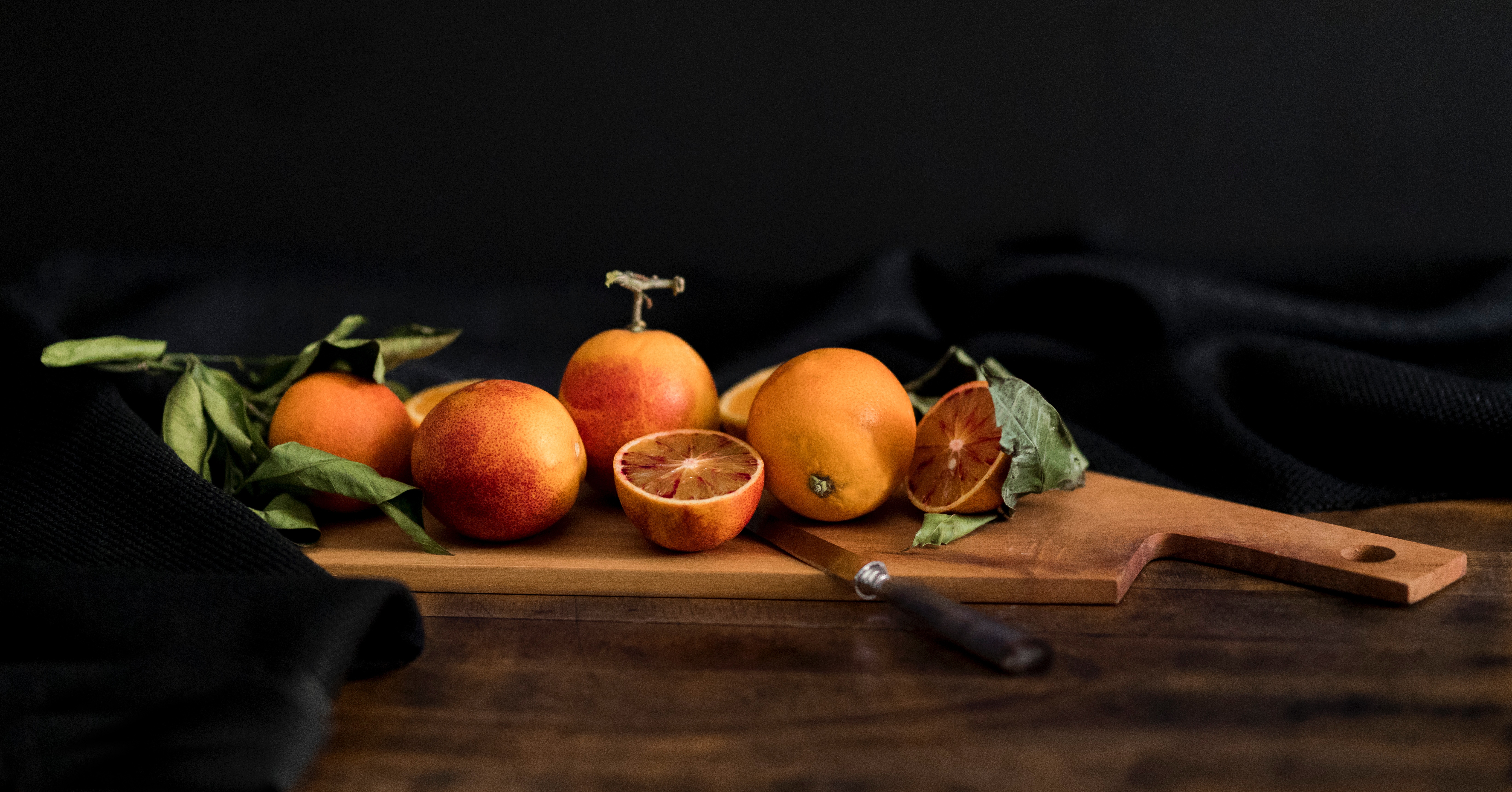 6569x3443 chop, knife, wooden, citrus, food, black background, PNG image, chopping board, blood orange, black, citru, platter, composition, slice, fruit, belgium, orange, brussels, green, studio, cut Gallery HD Wallpaper