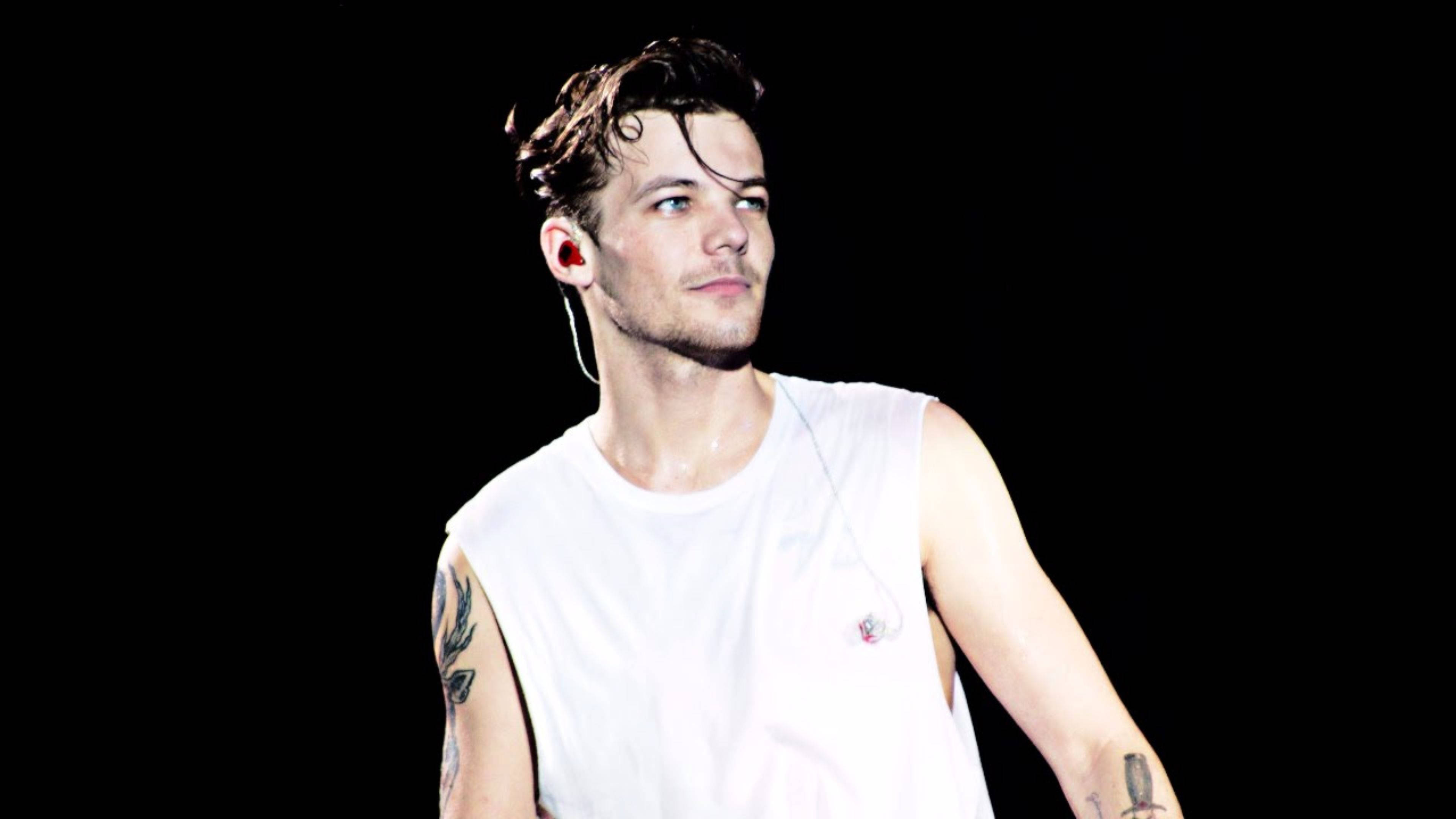 Download Louis Tomlinson In A Sleeveless Shirt Wallpaper