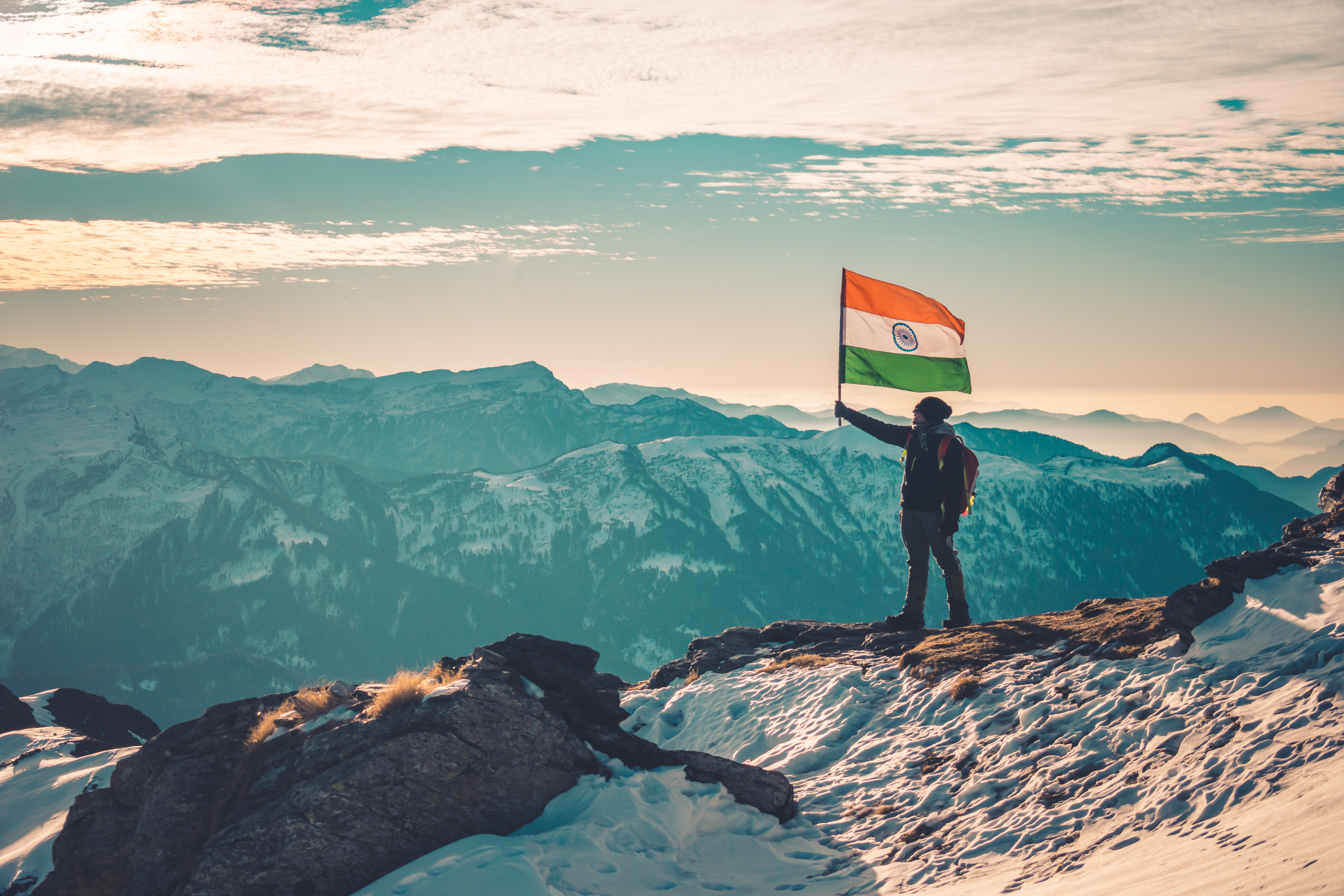 A Man Holding an Indian Flag While Standing in the Himalayas · Free