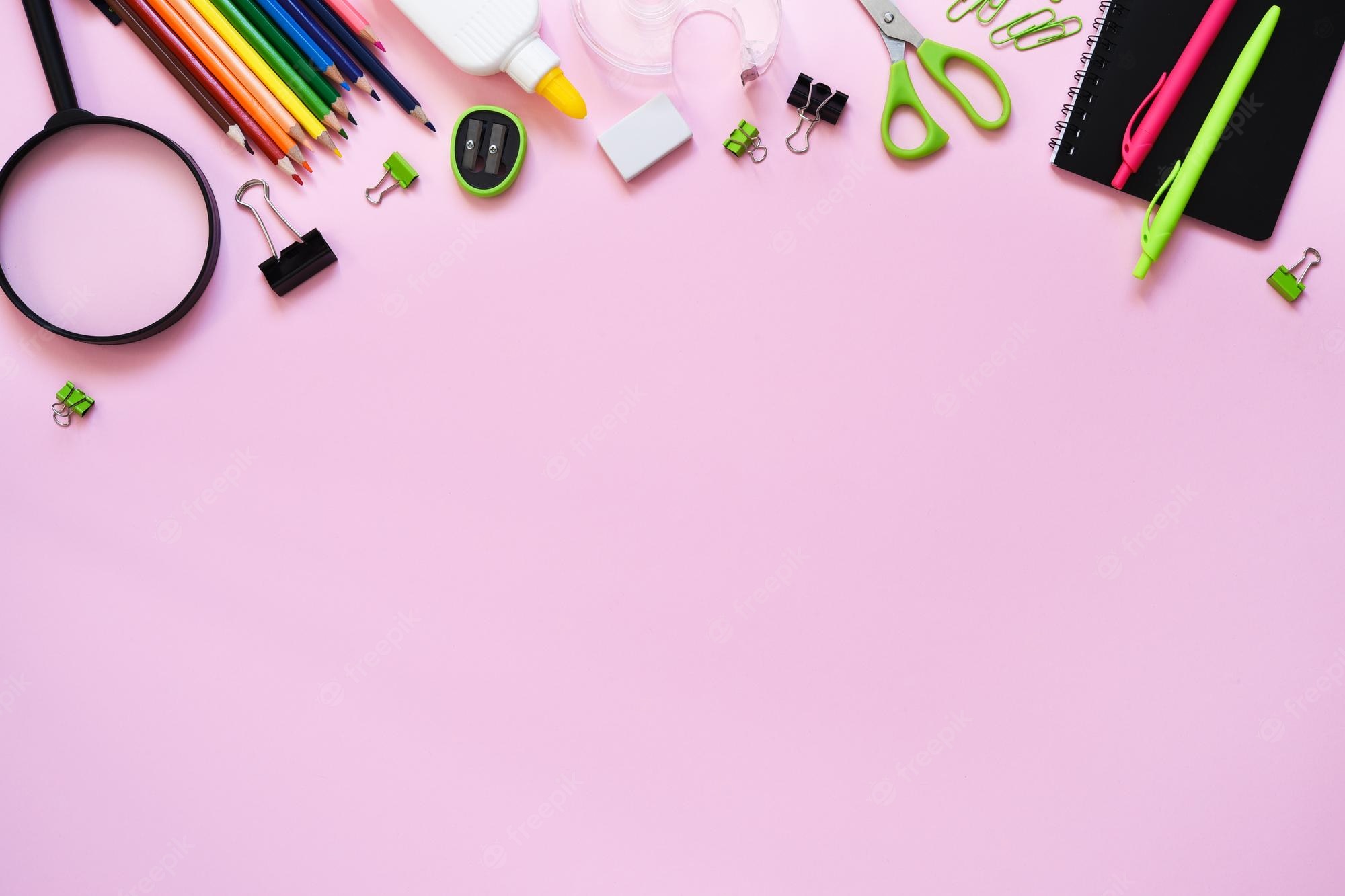 Premium Photo. School supplies on a paper pink background back to school